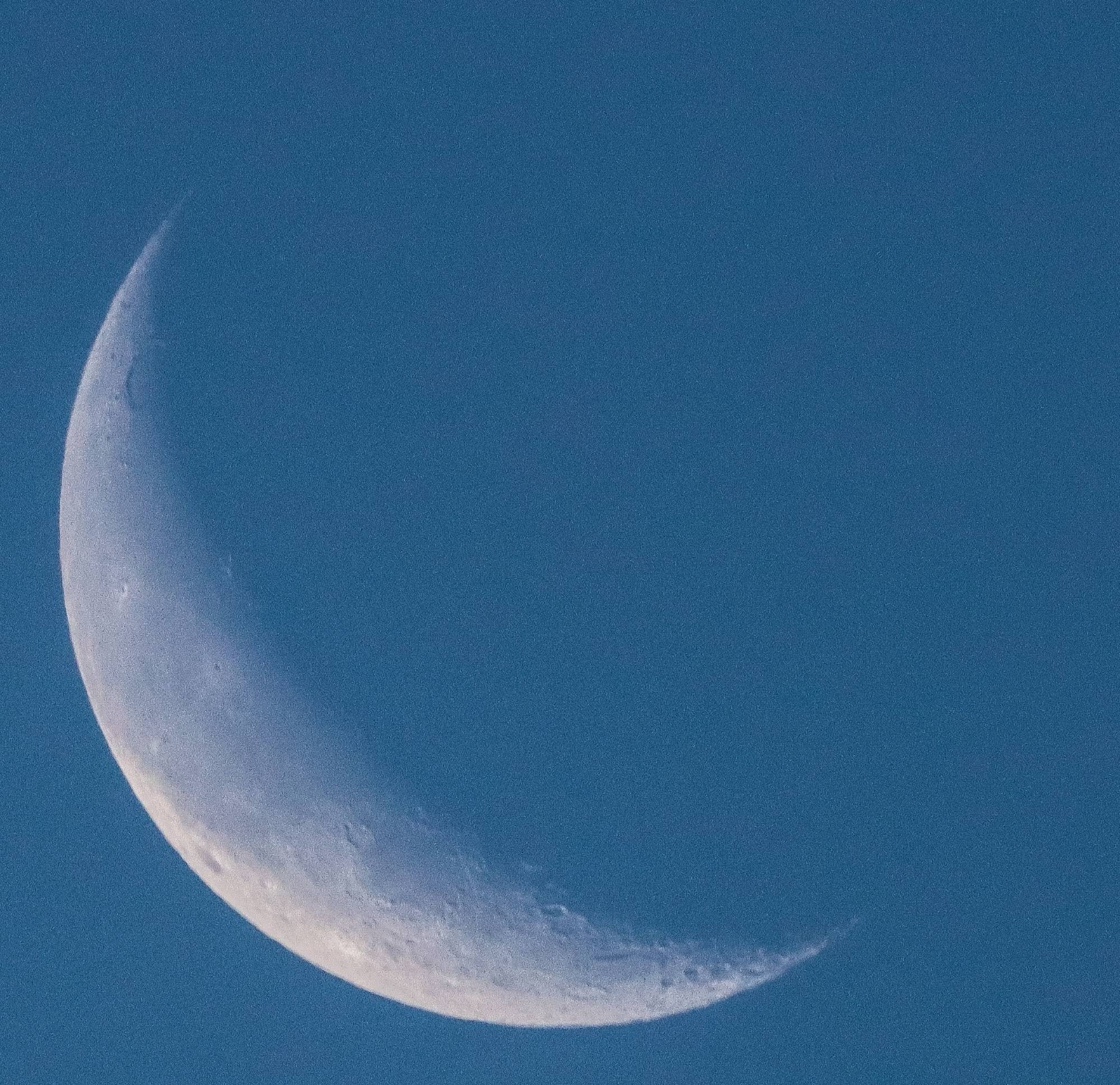 Image of Crescent Moon against morning blue sky