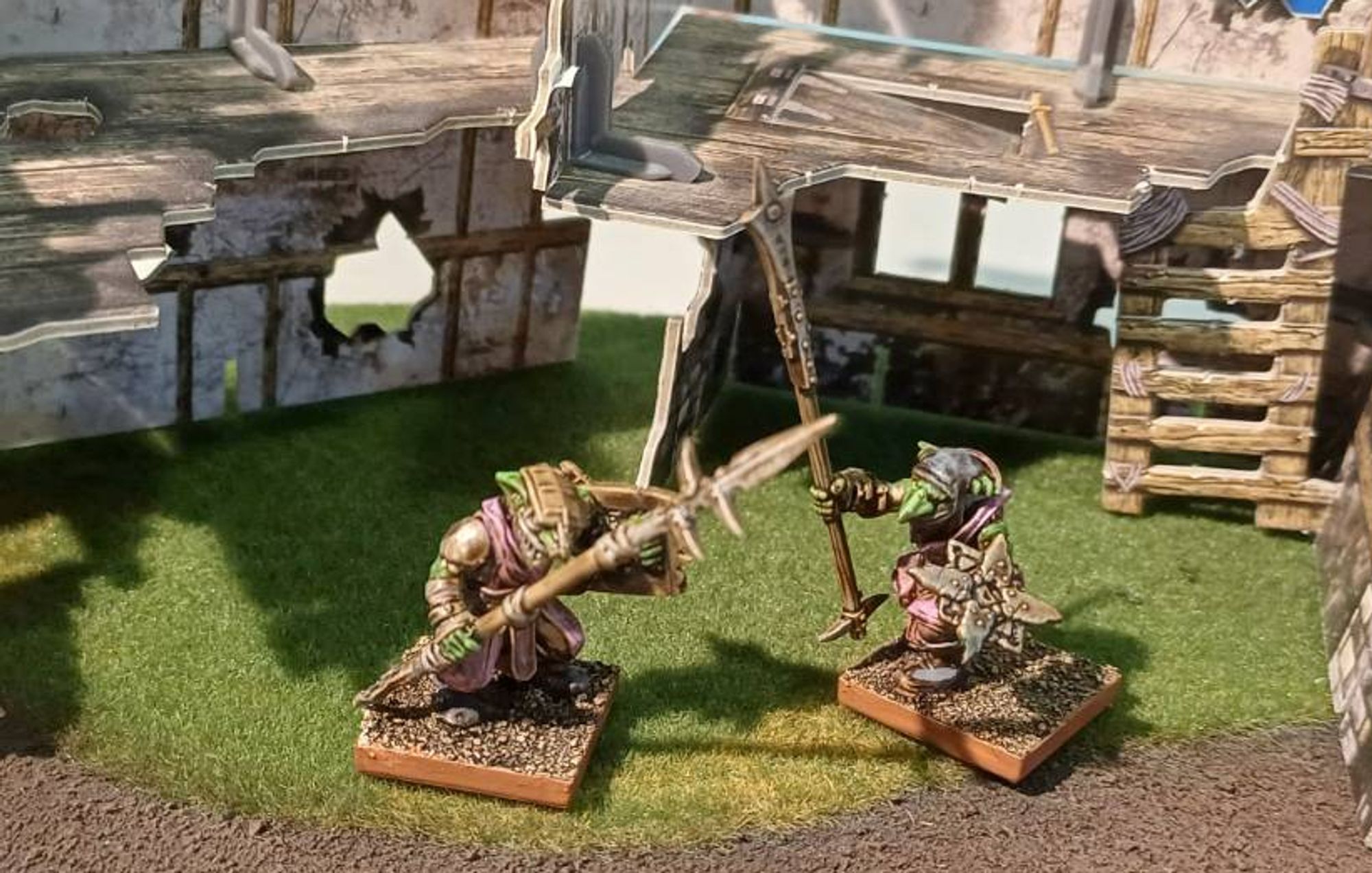 Photo: two goblin spearmen standing in front of a pair of ruins