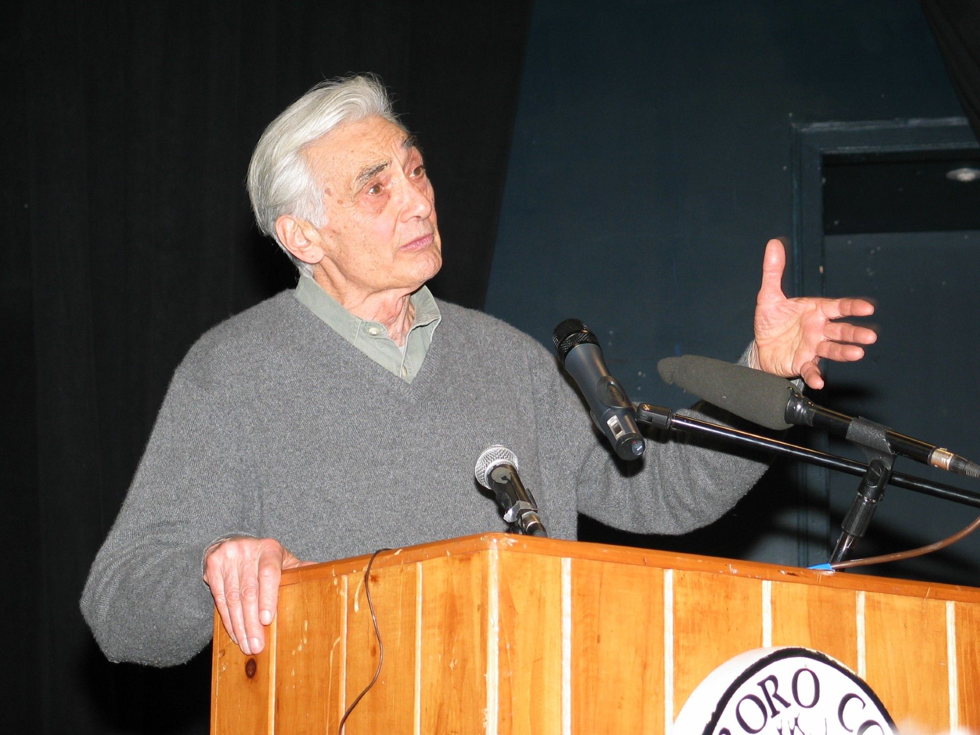 Image of a man speaking at a podium.