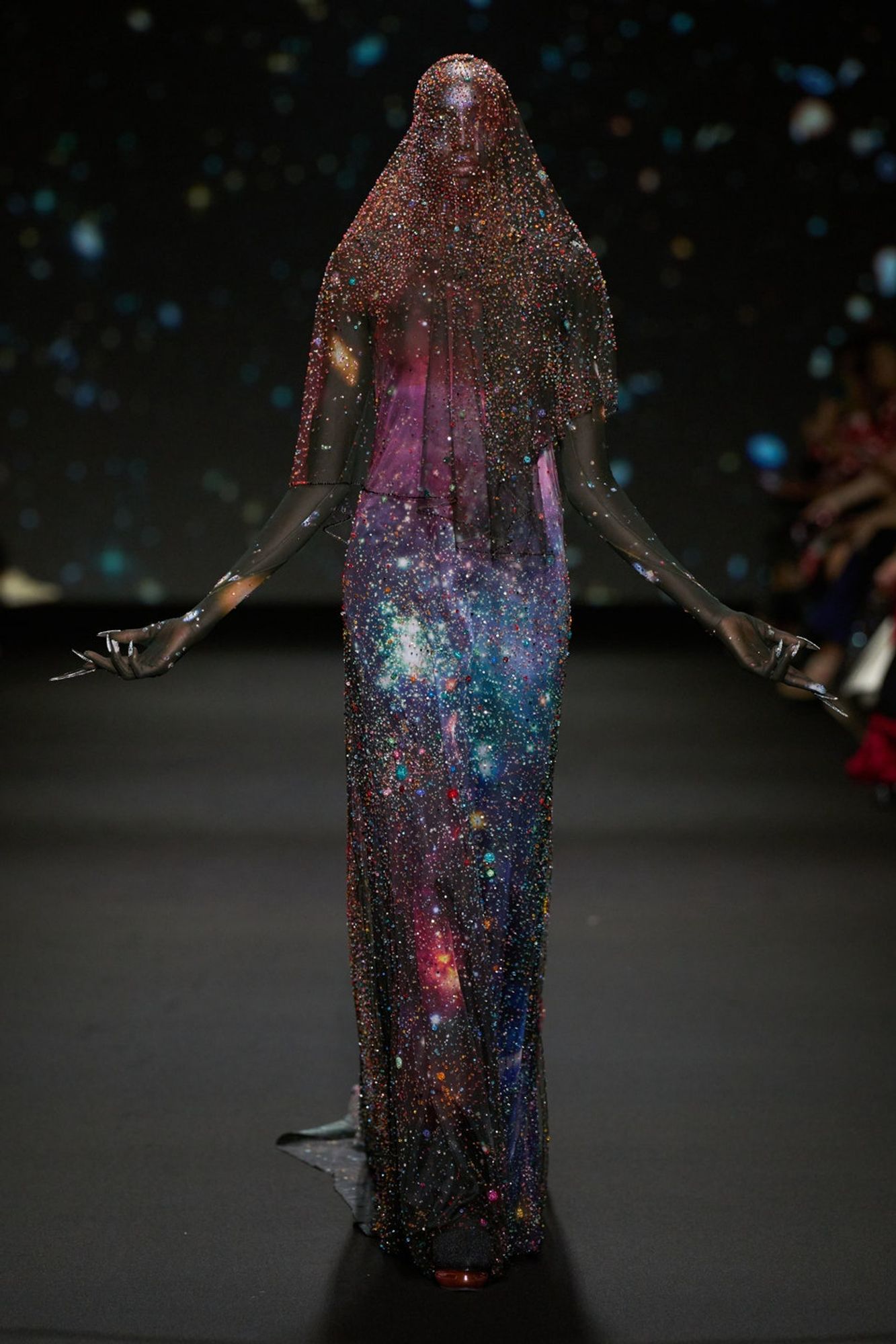 a dress that appears cosmic with black, shades of purple, pink, red, and blue. it reminds me of a nebula