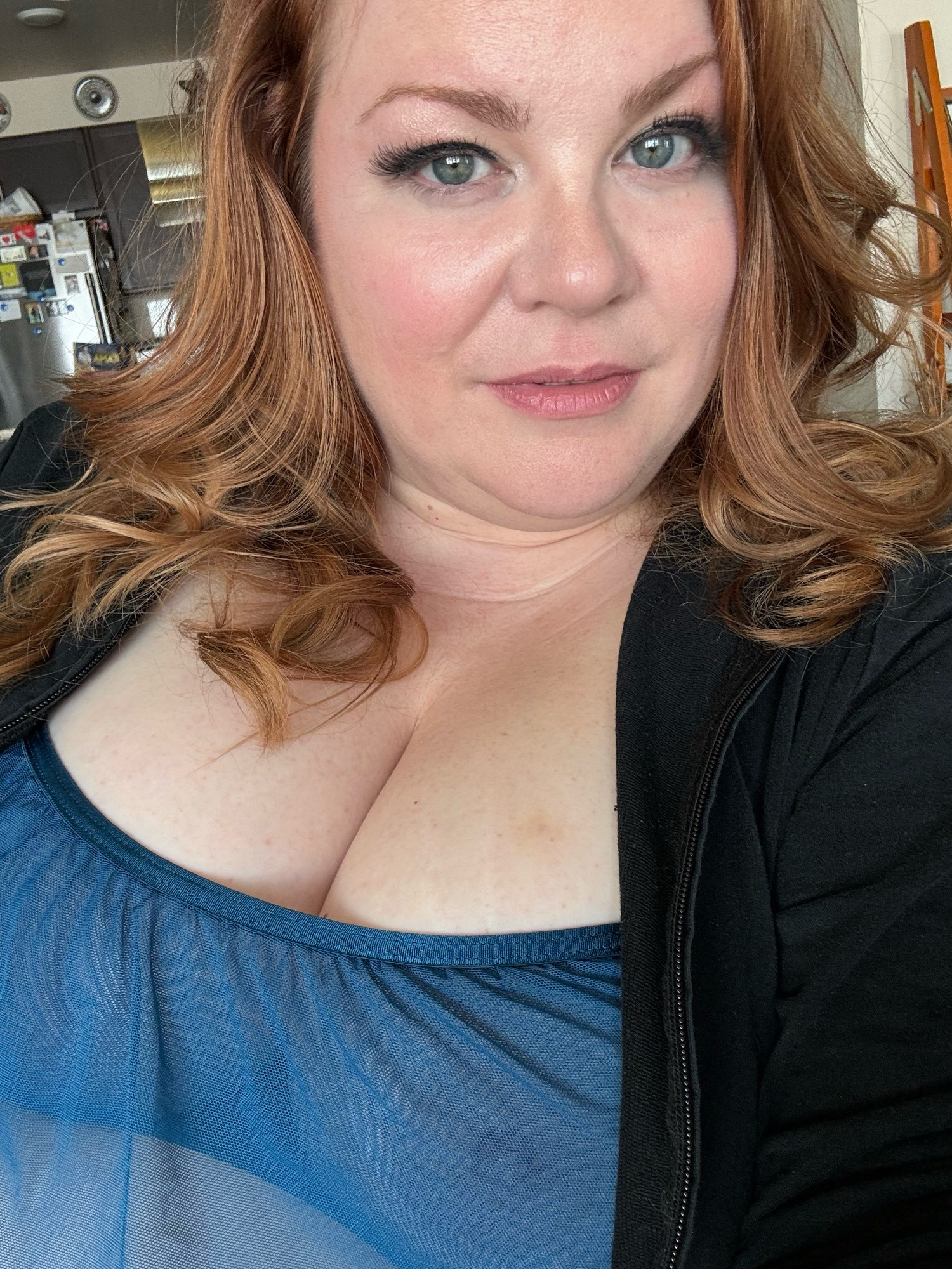 Selfie with sheer blue top under a black hoodie. Nipple lightly visible underneath…