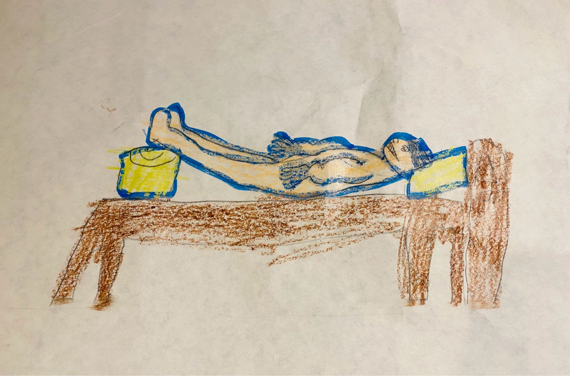 A crayon drawing of a naked woman with strange hands and a big smile lying on her back on a wooden bed. Her head is propped up on a yellow pillow and so are her feet.