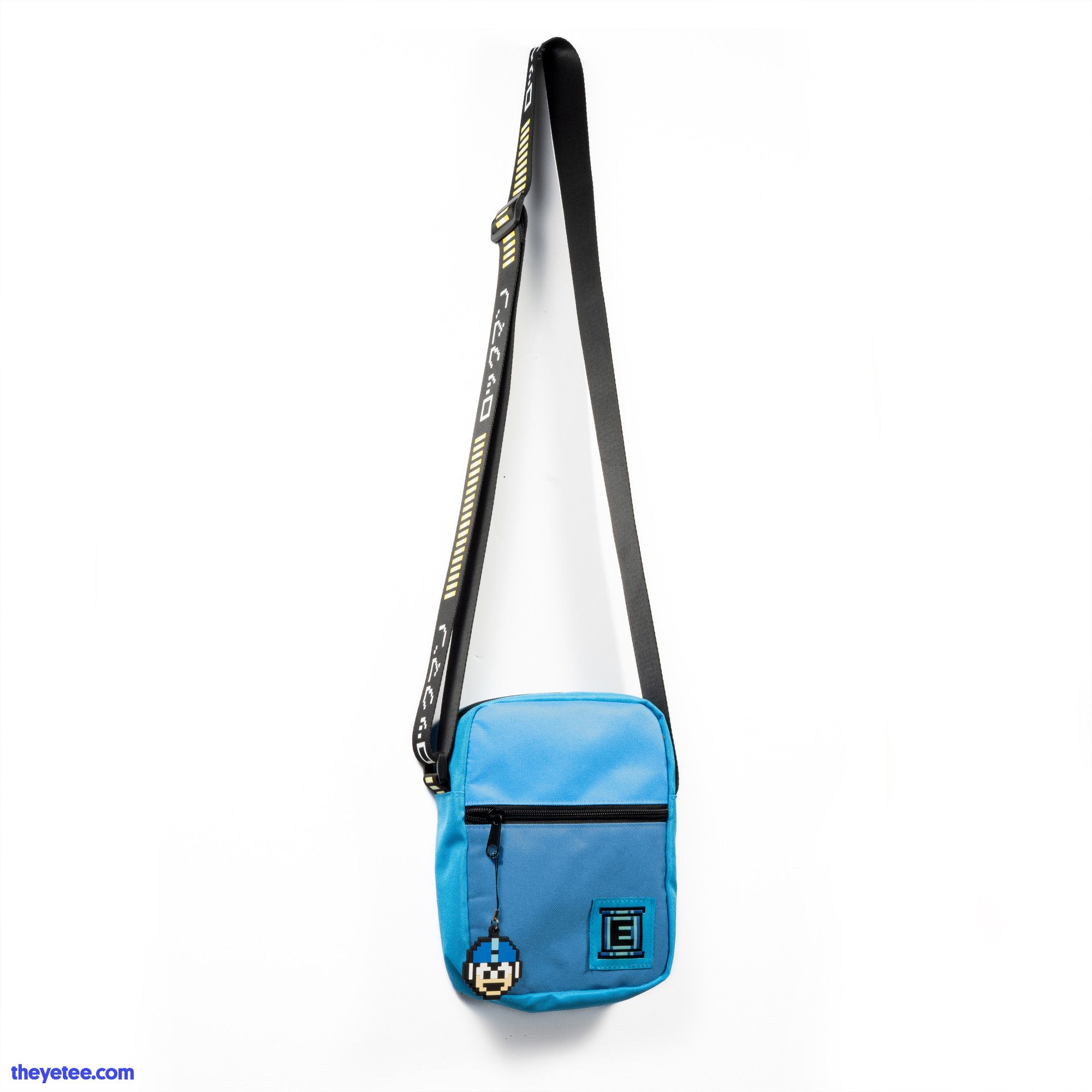 Blue Mega Man Shoulder Bag. It is Blue with a Light Blue accent. There is a E Tank patch in the bottom corner. It also features a Mega Man 1 Up Zipper Pull. The strap is black and has a printed energy bar on it.