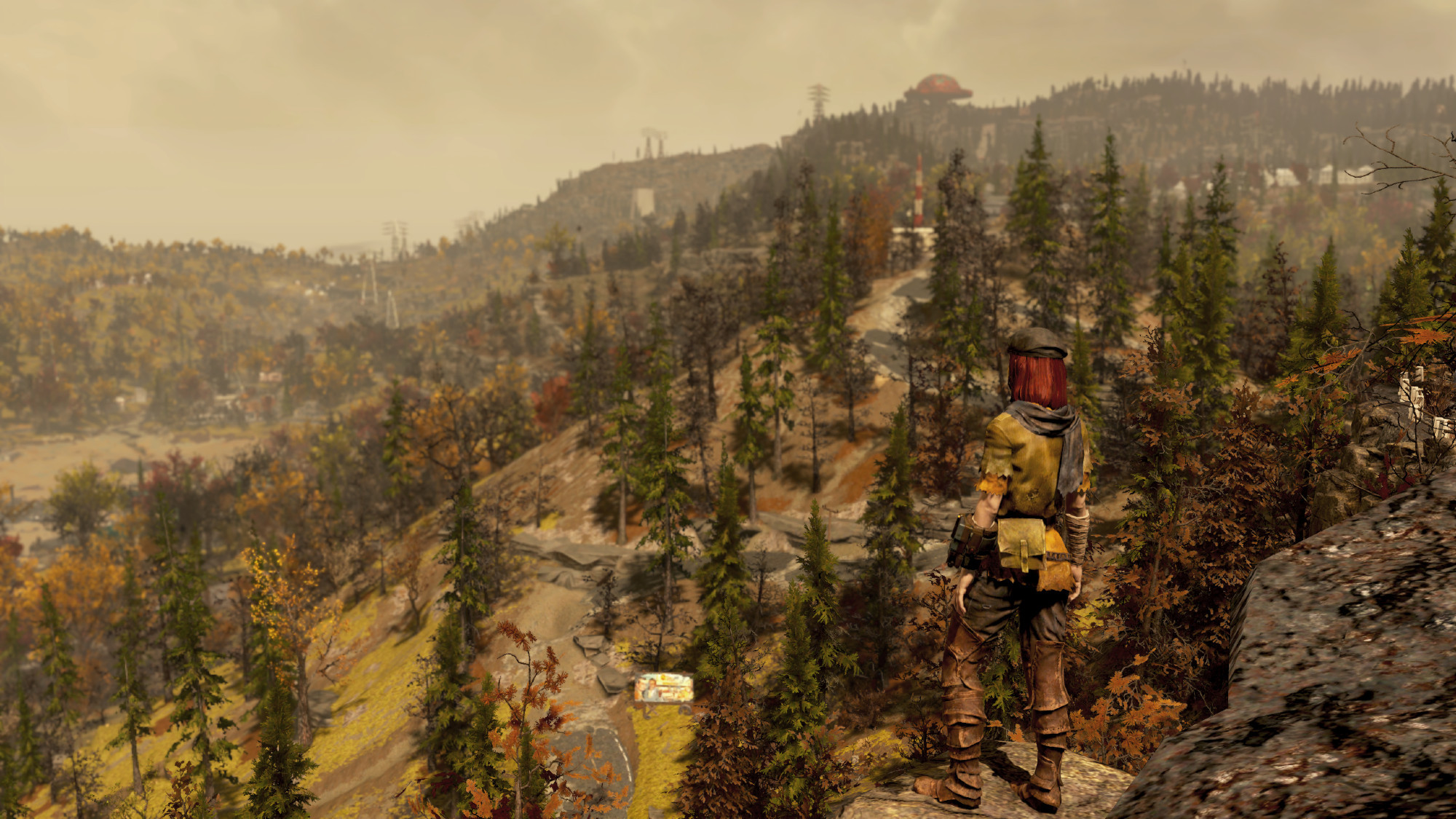 Another Fallout 76 screenshot of my character looking down at an autumnal landscape in Appalachia from the top of a mountain.