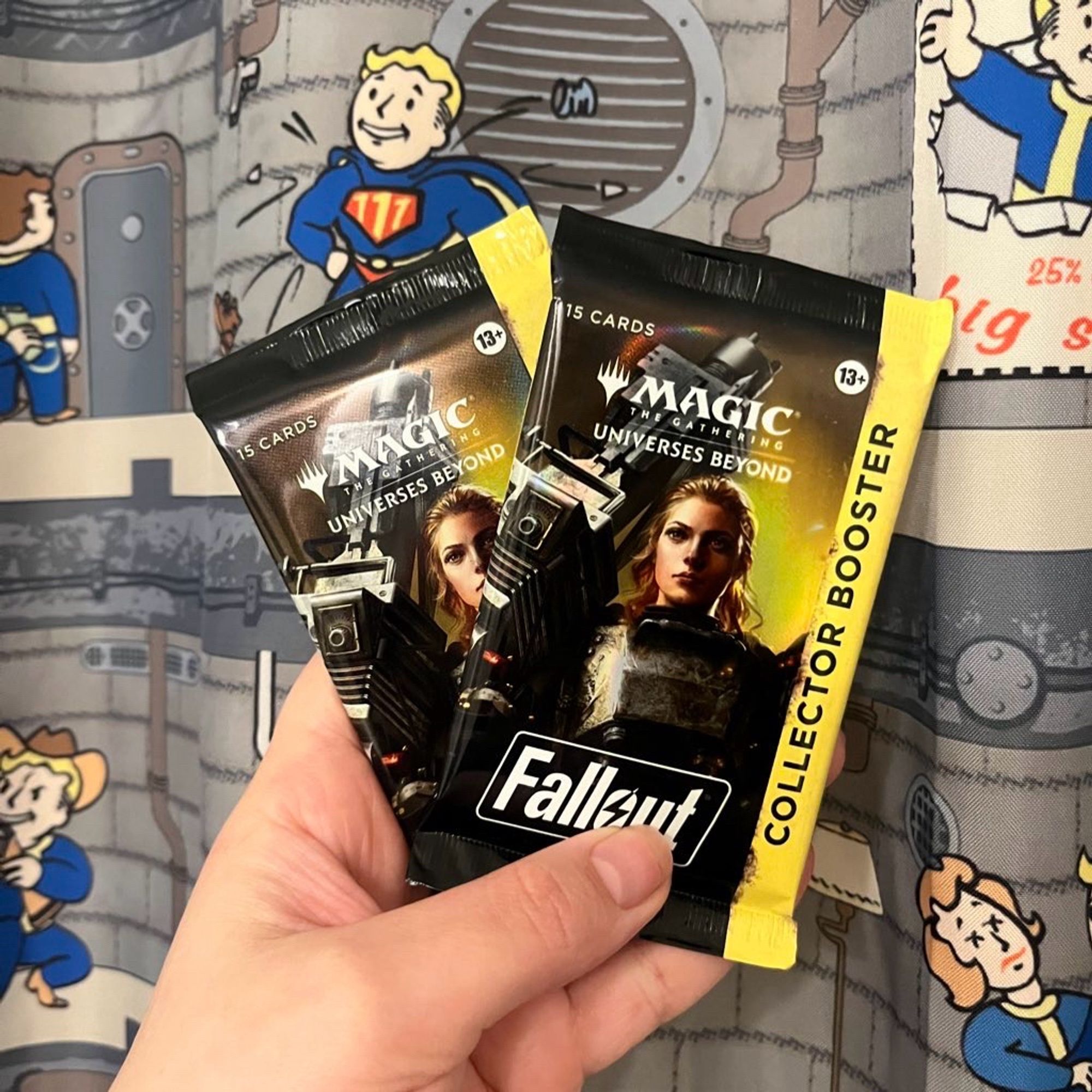 Kels holds two magic the gathering fallout themed booster packs before a vault boy perk chart background