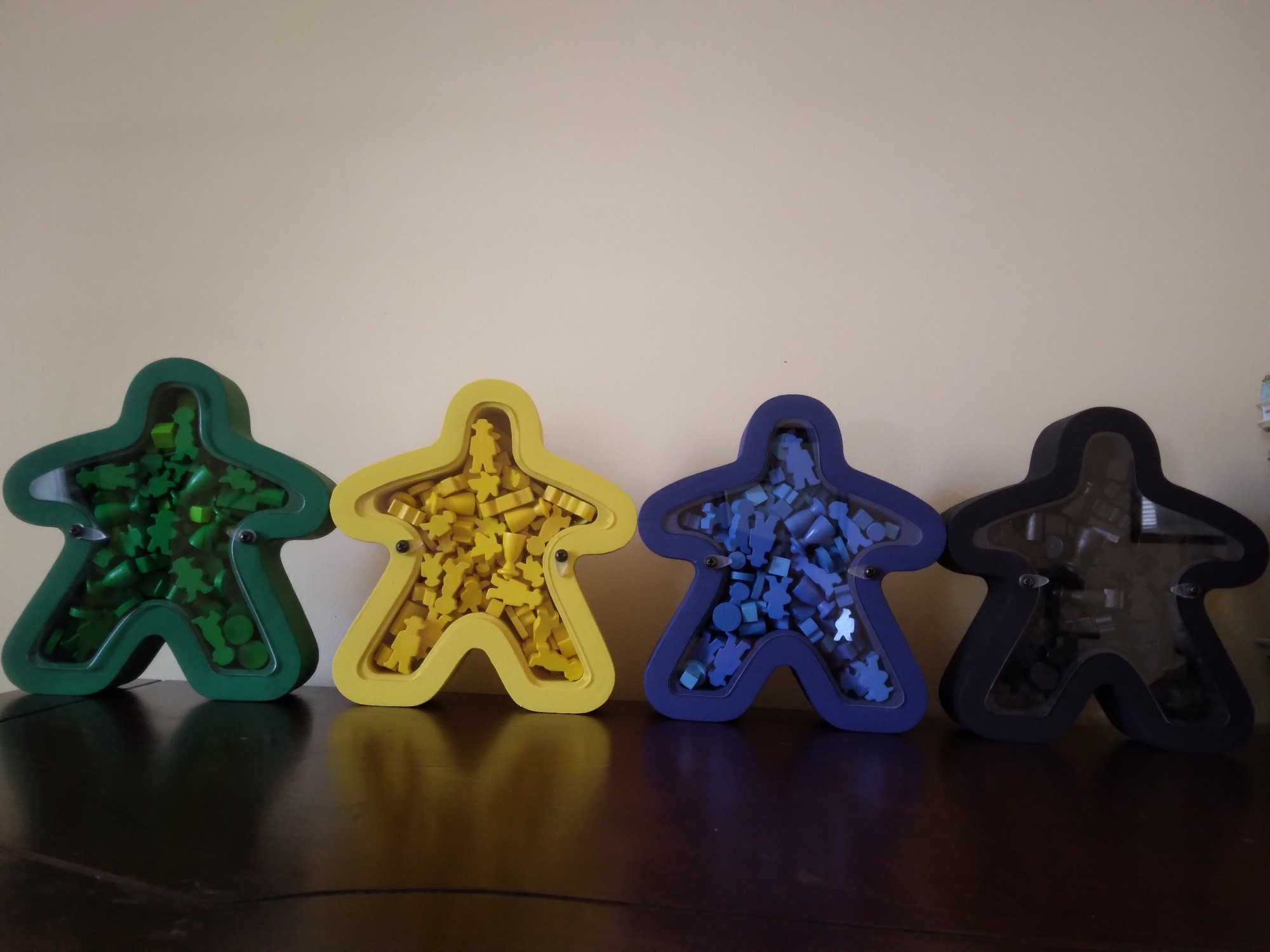 Meeples filled with components.