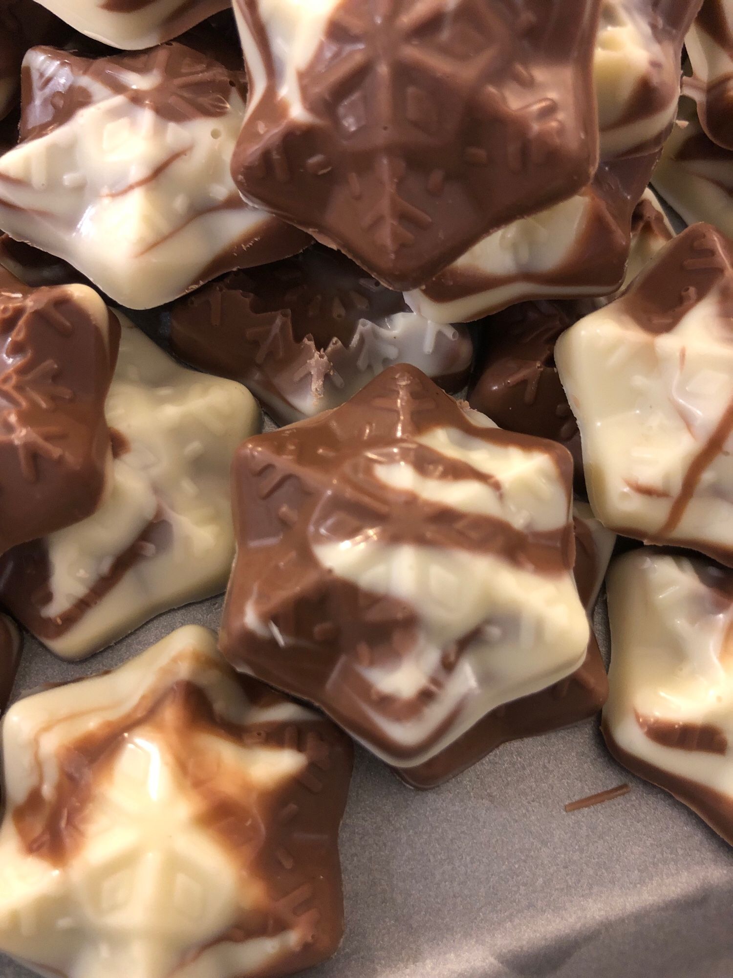 Home made moulded chocolate snowflakes, a swirled mixture of white chocolate & orange flavoured milk chocolate.