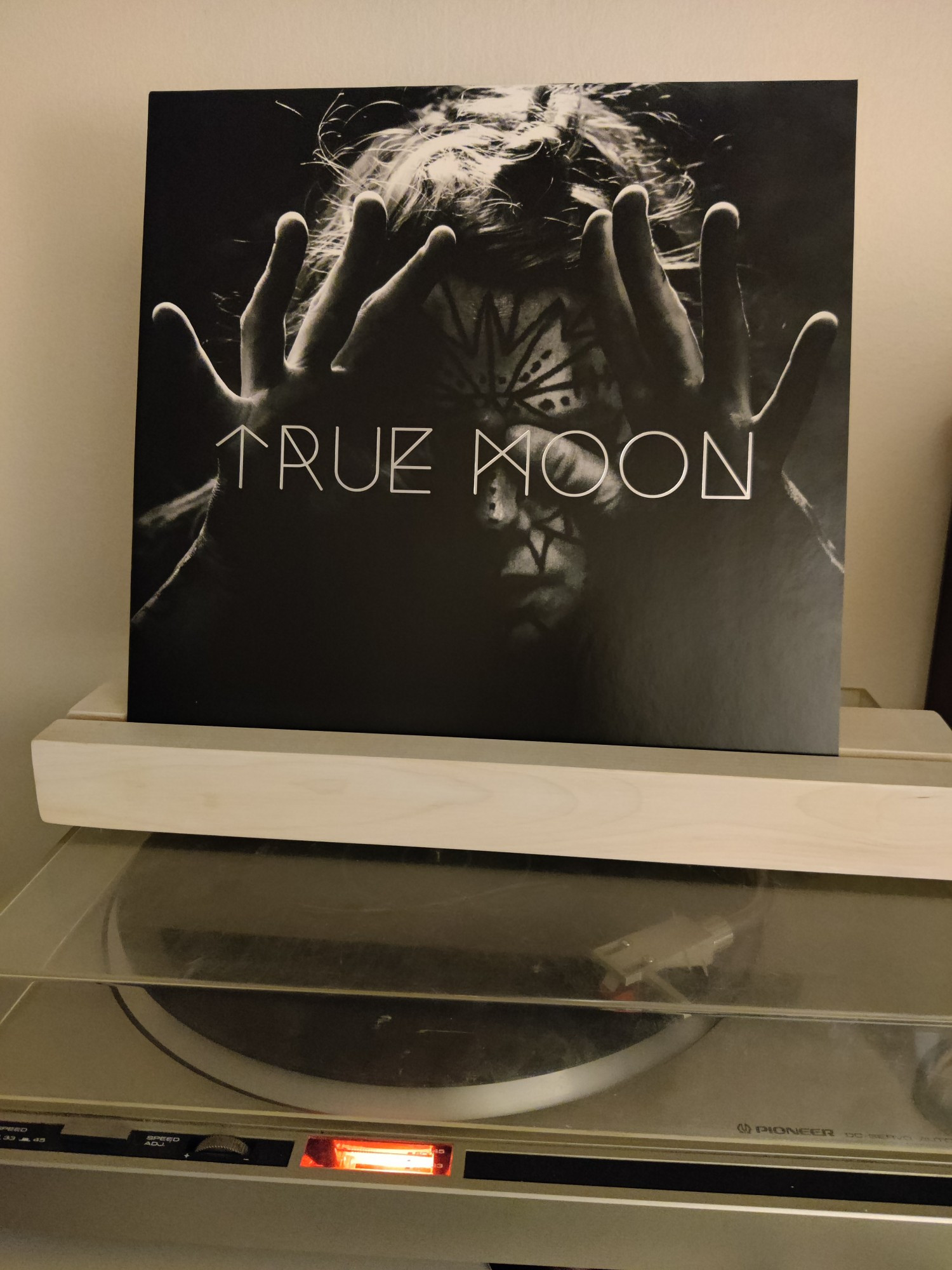 Vinyl album "S/T" by True Moon on a record player. 