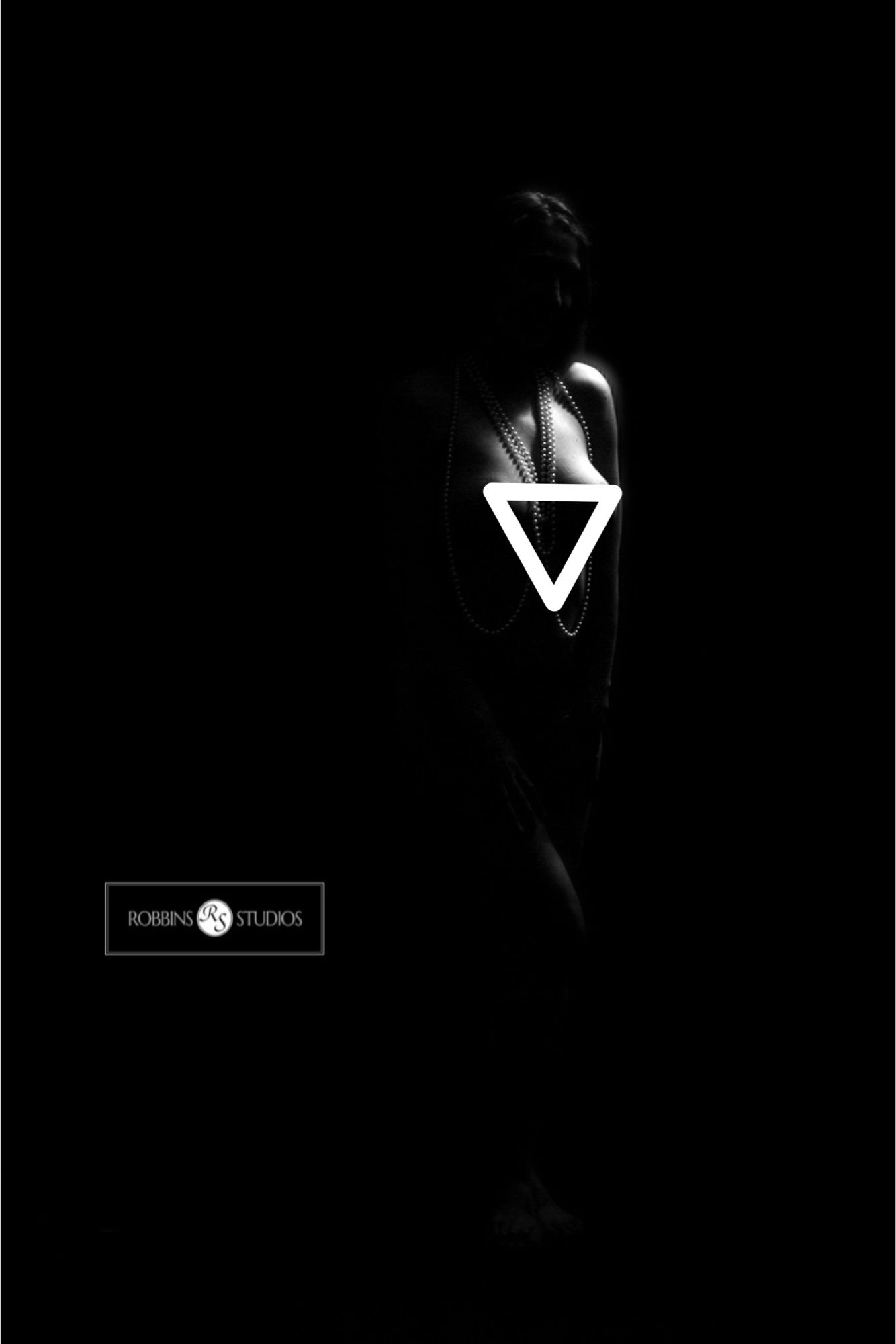 Black & white nude in shadow with artfully placed censorship triangle