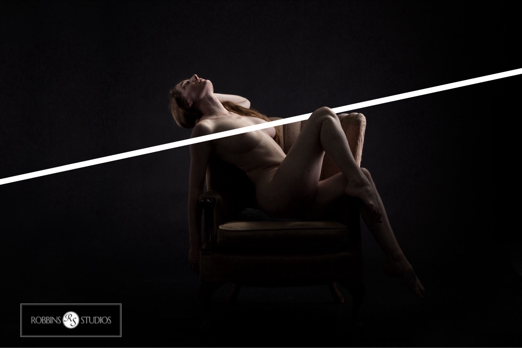 Nude photo of a woman in a chair with artfully placed censorship bar.