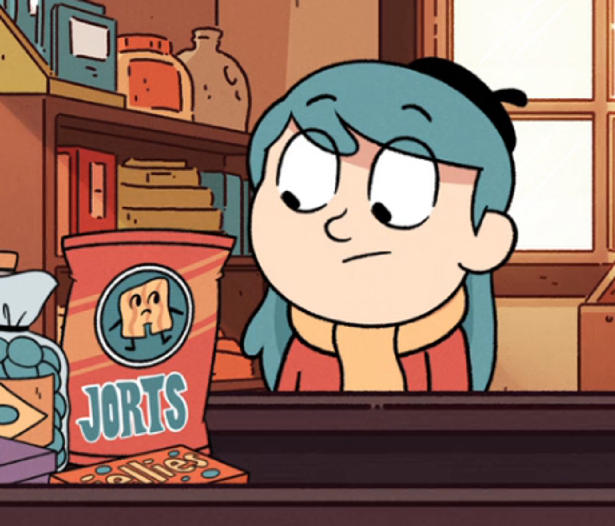 Hilda (a cartoongirl with teal hair a beret a scarf and a red sweater) stares at a bag of snacks labled "Jorts". The jort snack on the bag looks back at her creepily. They both have dubious expressions. There's a few other snacks on the table where the jorts sit, behind hilda is a shelf of curios.