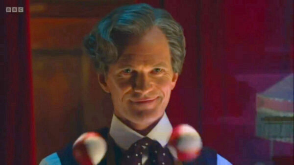 Neil Patrick Harris as The Toymaker in Doctor Who, juggling balls, an evil smirk on his face.