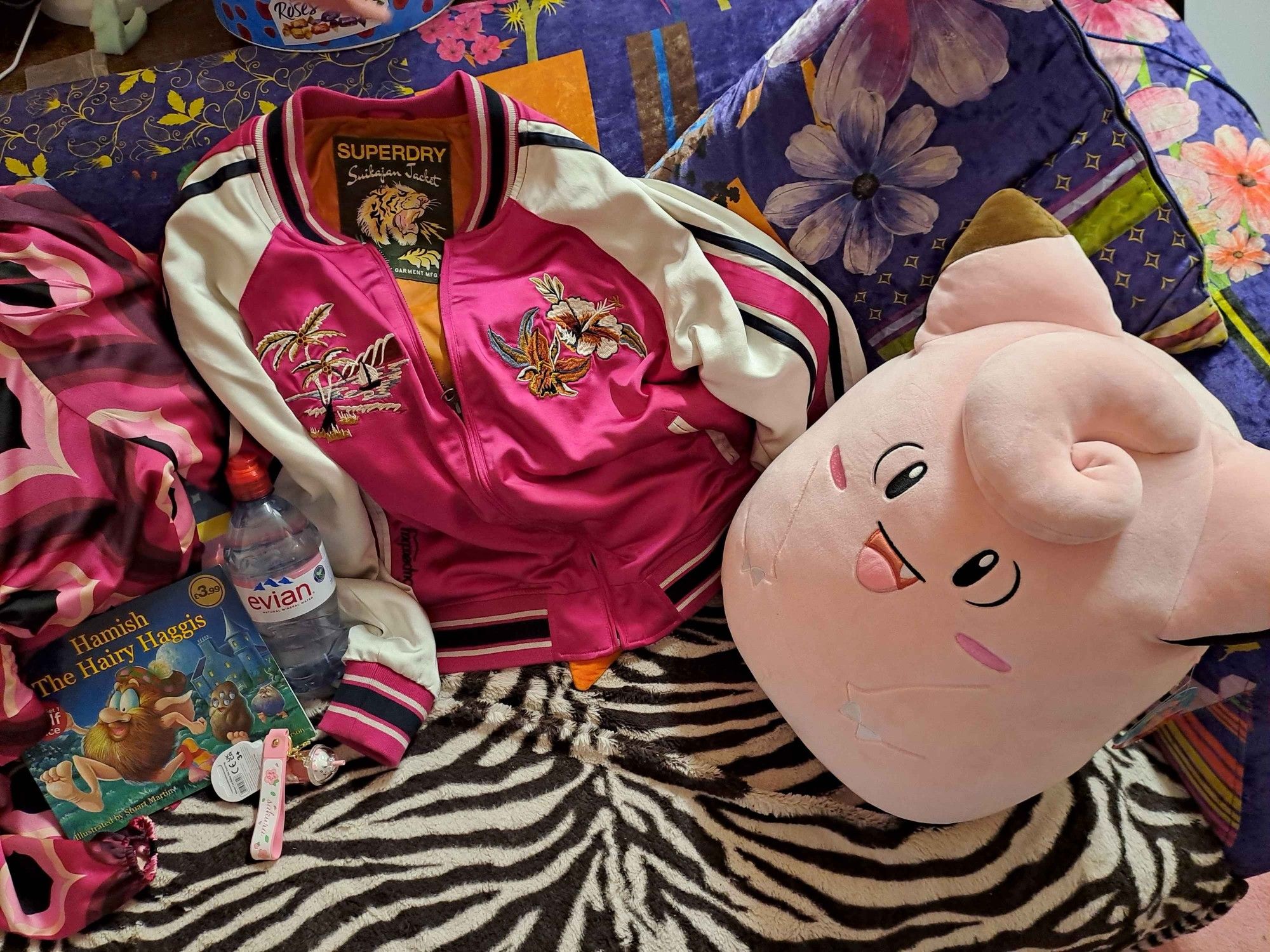 i got two pink tops (one hawaiian), a giant clefairy squishmallow, Hamish The Hairy Haggis storybook, sakura bubble milk tea keychain, and some evian water. the ita bag was the bag i took with me to Nessie's city :3