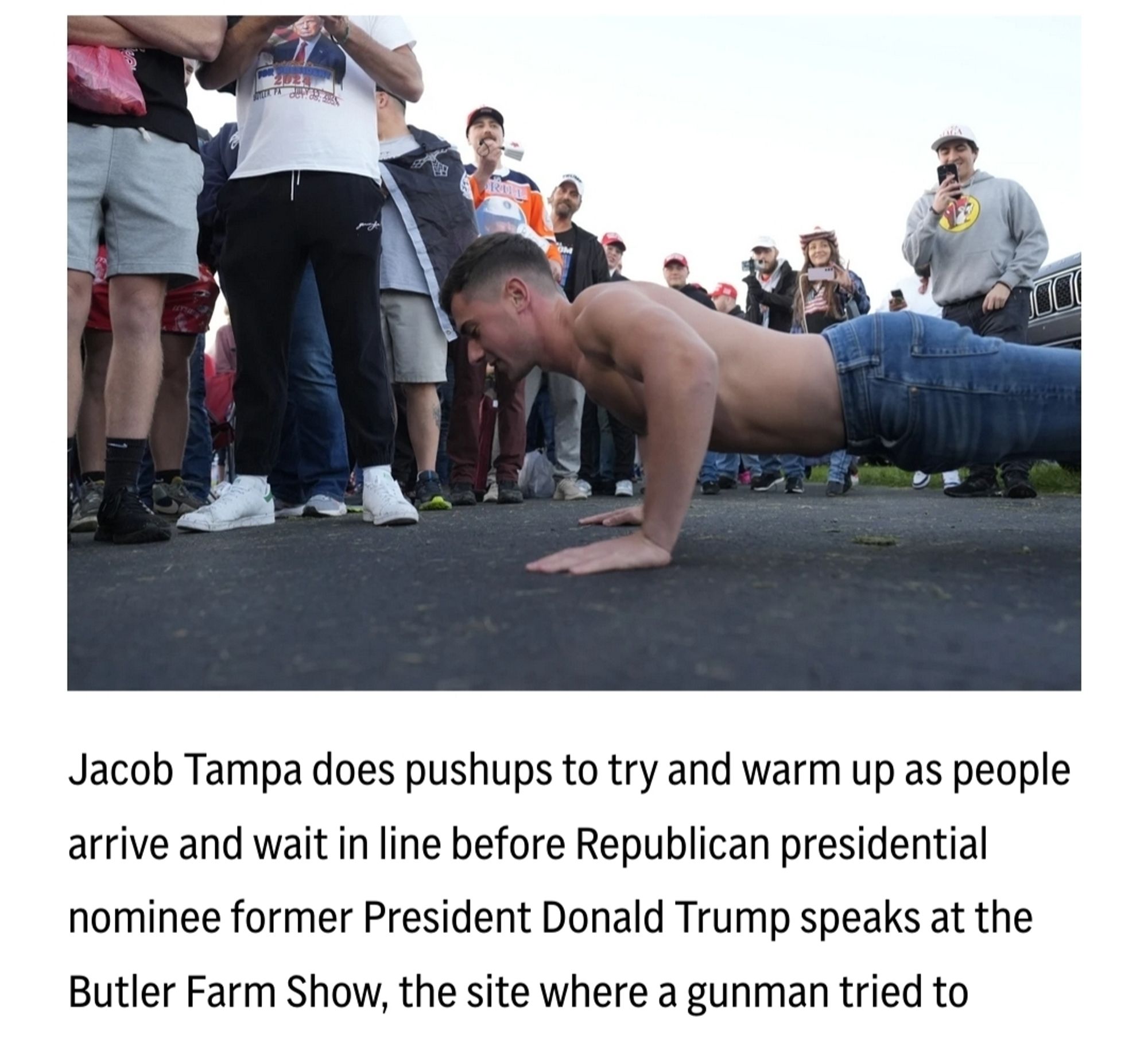 Jacob Tampa does pushups to try and warm up as people
arrive and wait in line before Republican presidential
nominee former President Donald Trump speaks at the
Butler Farm Show, the site where a gunman tried to