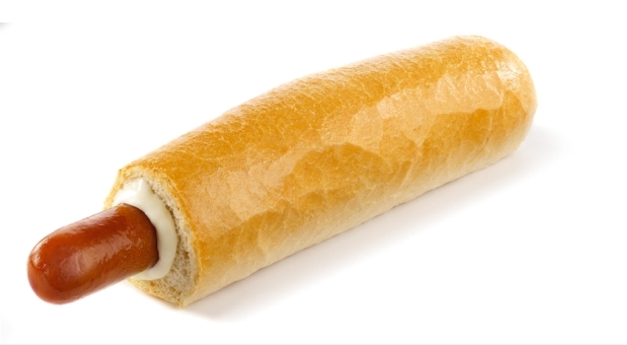 A hotdog sticking out of an unsliced baguette that's been essentially circumcised to reveal a length of weiner