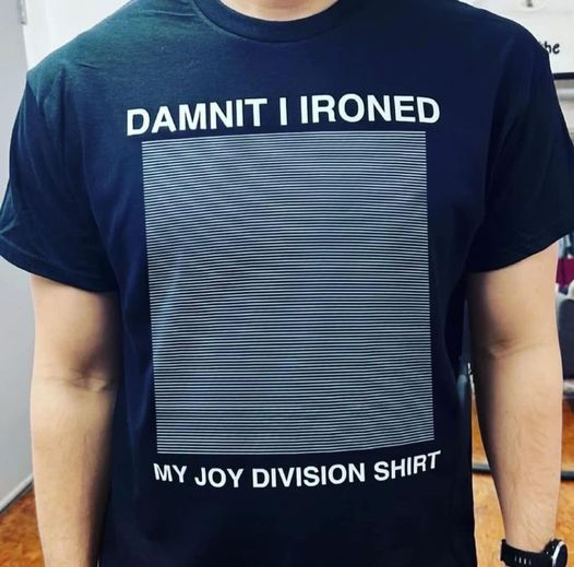 T-shirt with a bunch of straight lines and the words "Damnit I ironed my Joy Division T-shirt"