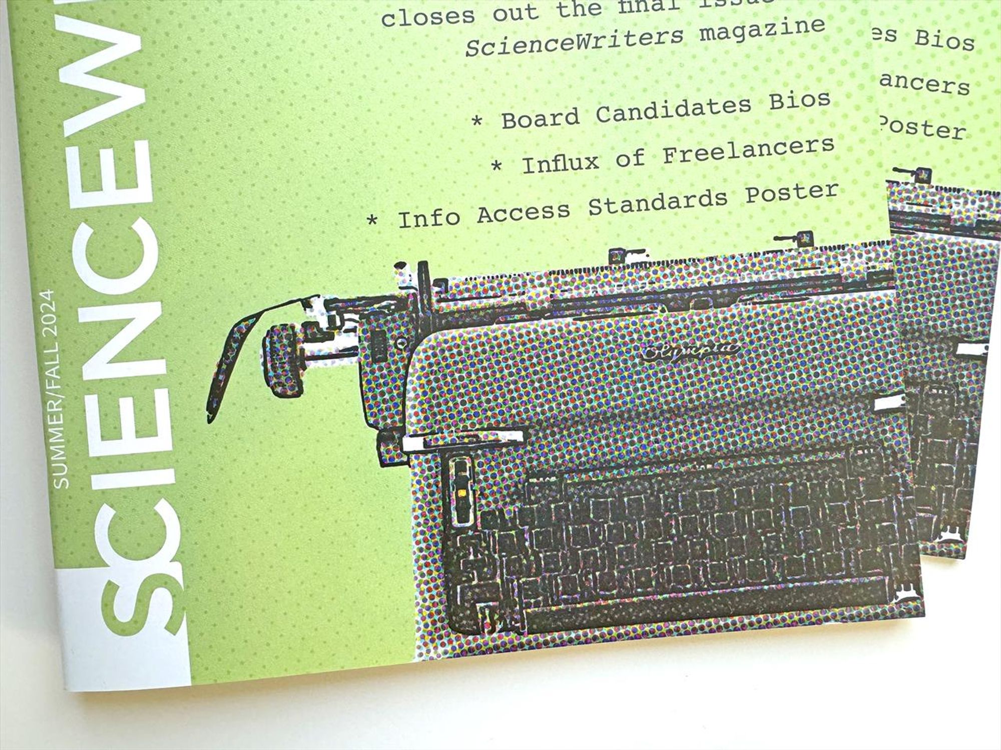 Photo of two Science Writers magazine stacked offset, with the cover depicting an old Olympic typewriter in a halftone print motif. Visible copy reads Board Candidate Bios, Influx of Freelancers, Info Access Standards poster.