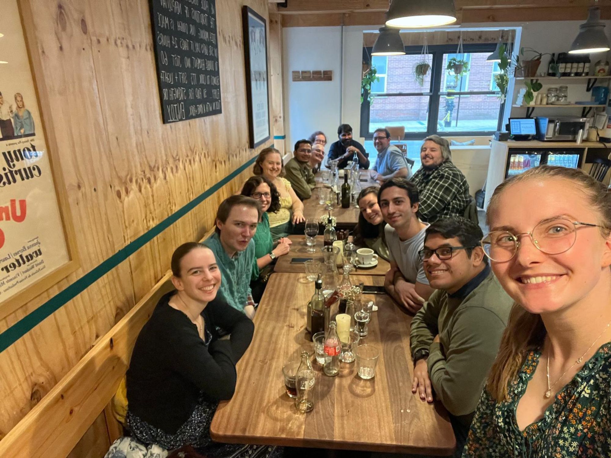 A group selfie with Jess Buddle in the foreground and friends around a table in the background