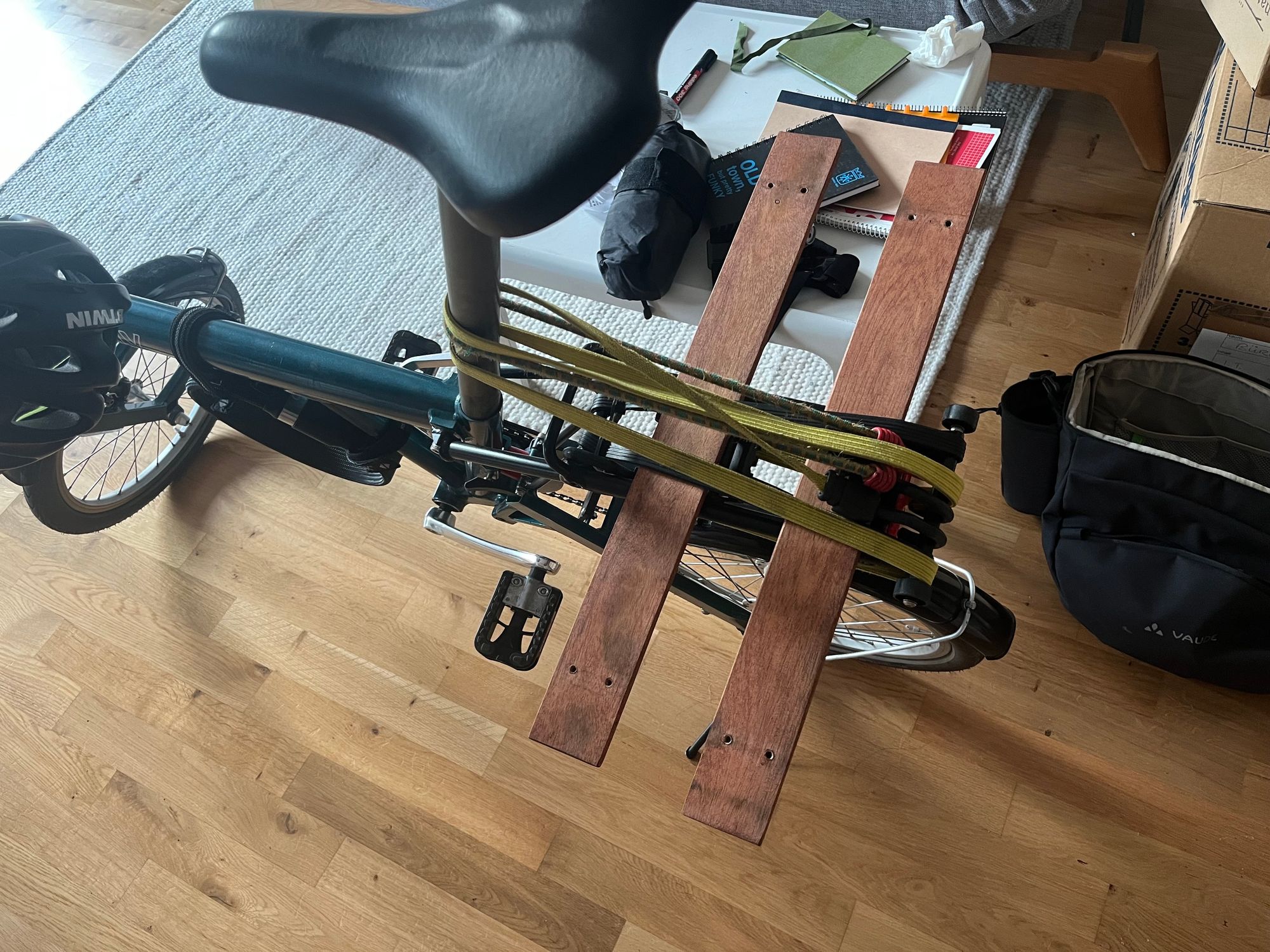 Back of a Birdy bike with two wood planks on the luggage rack 