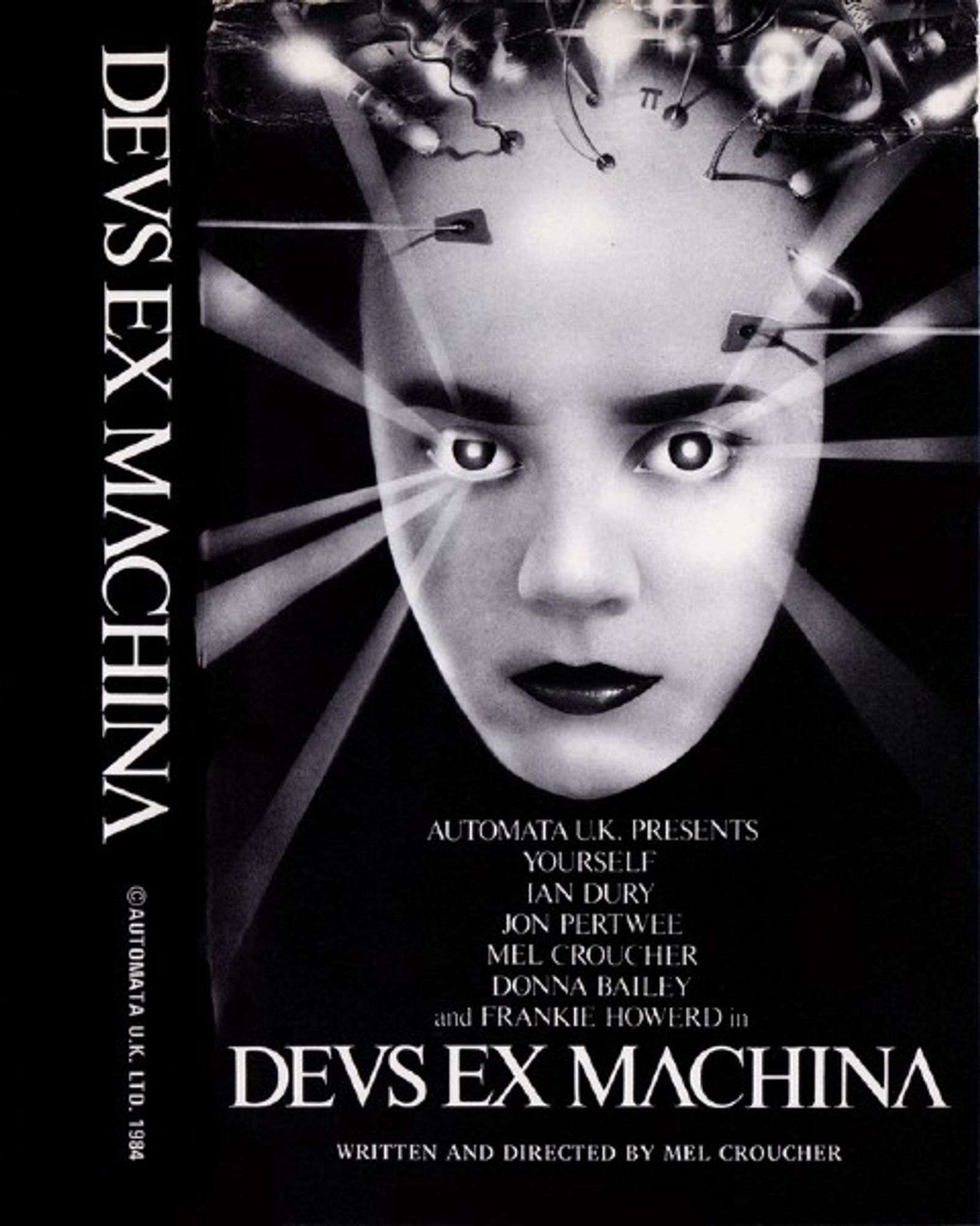 The cover to the computer game Deus Ex Machina, but for accuracy if not readability the text is authentically written as DEVS EX MACHINA.

A black and white photo of a bald-headed woman who gazes out of the cover. Light rays shine from her eyes. Her head is surrounded by wires and bits of technology. The picture has an art-deco feel and echoes the robot from Metropolis, without looking like it.