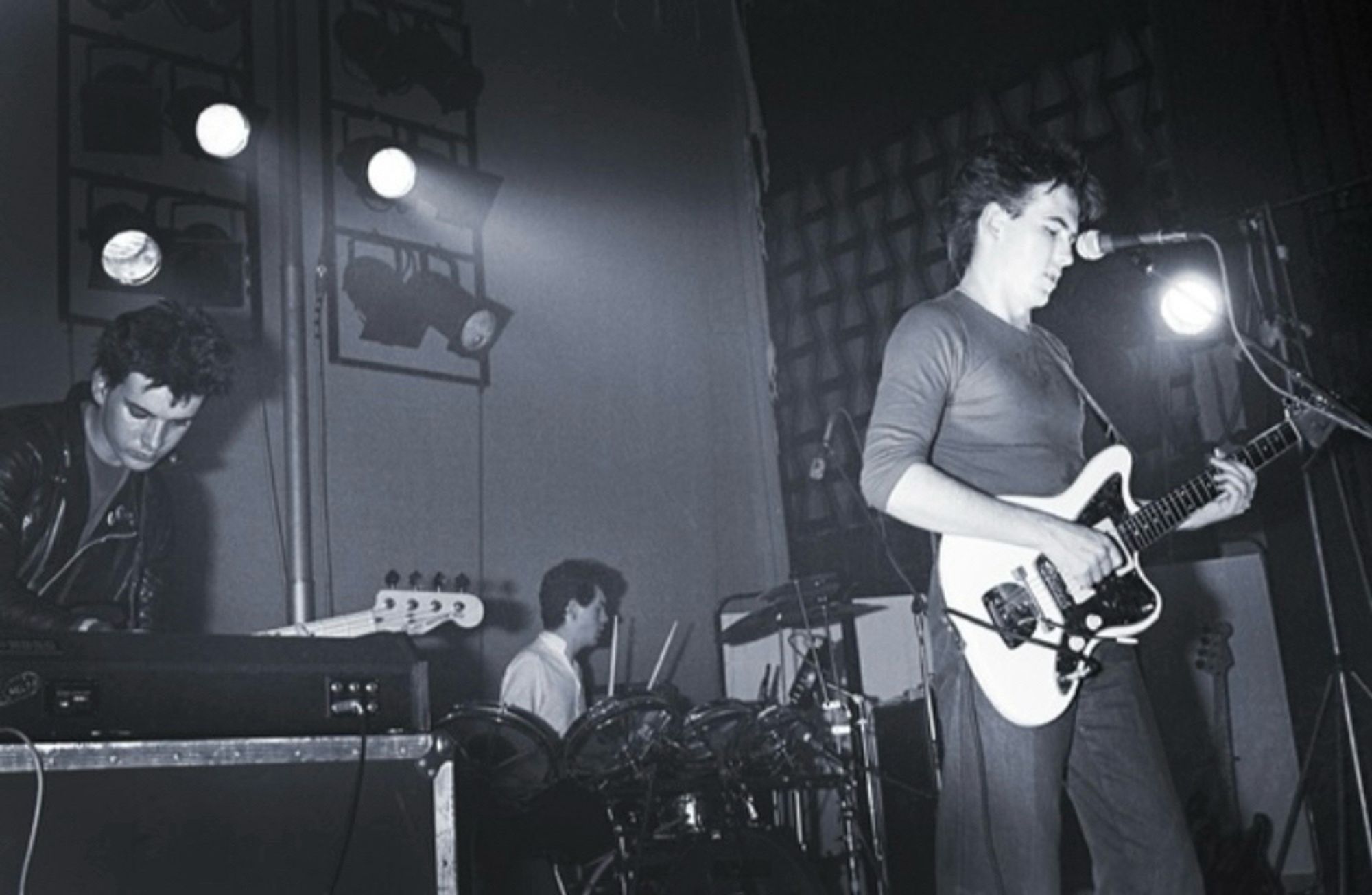 The Cure (l-r Simon Gallup, Lol Tolhurst, Robert Smith) on stage at Zaal Lux concert hall in Herenthout, Belgium in 1980.