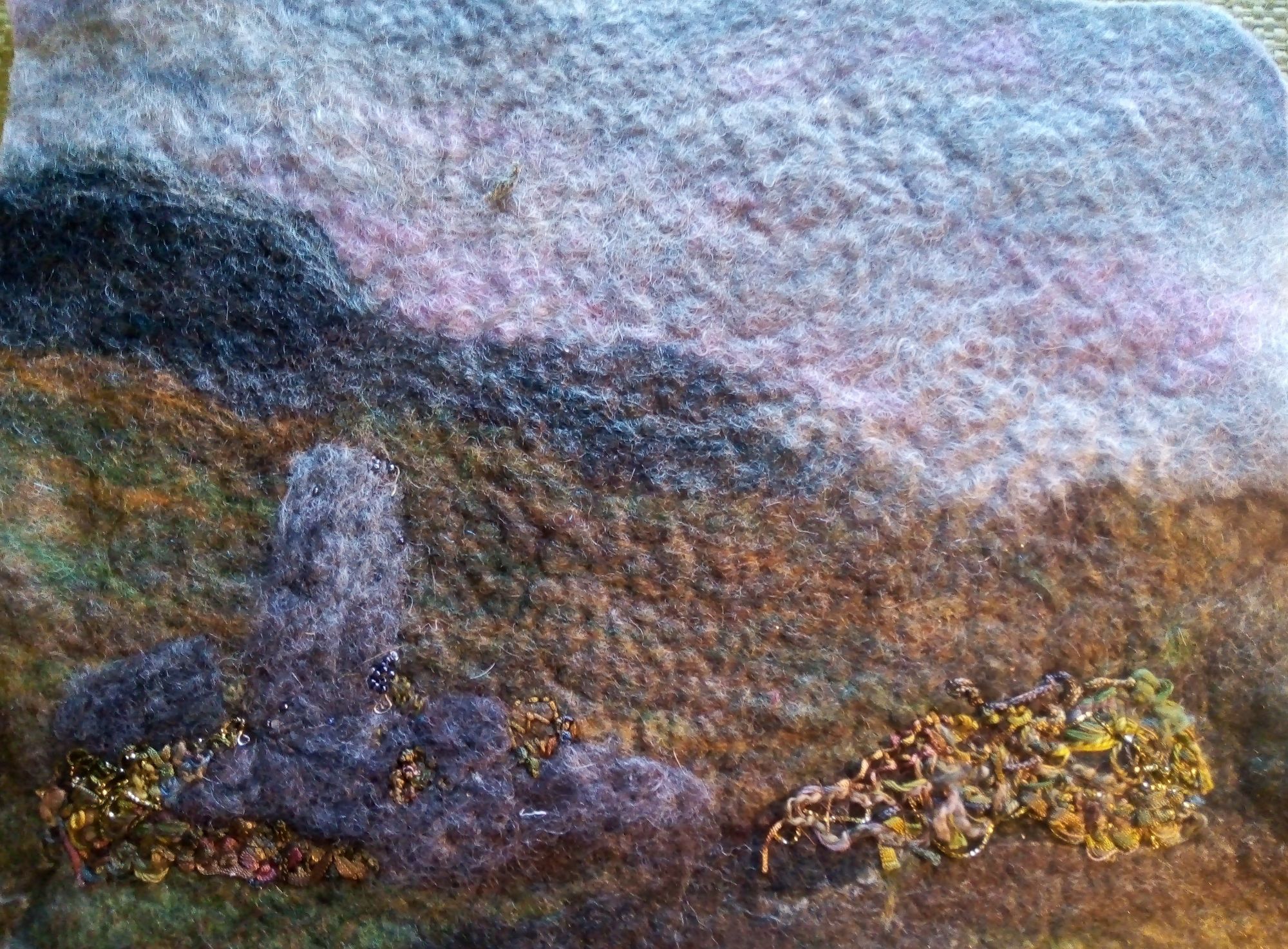 Felted wool landscape with standing stone to left.