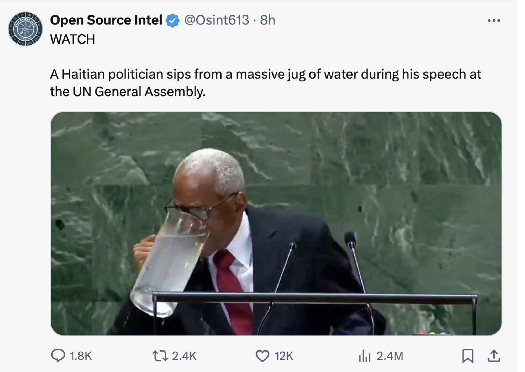 A man drinking a massive jug of water.