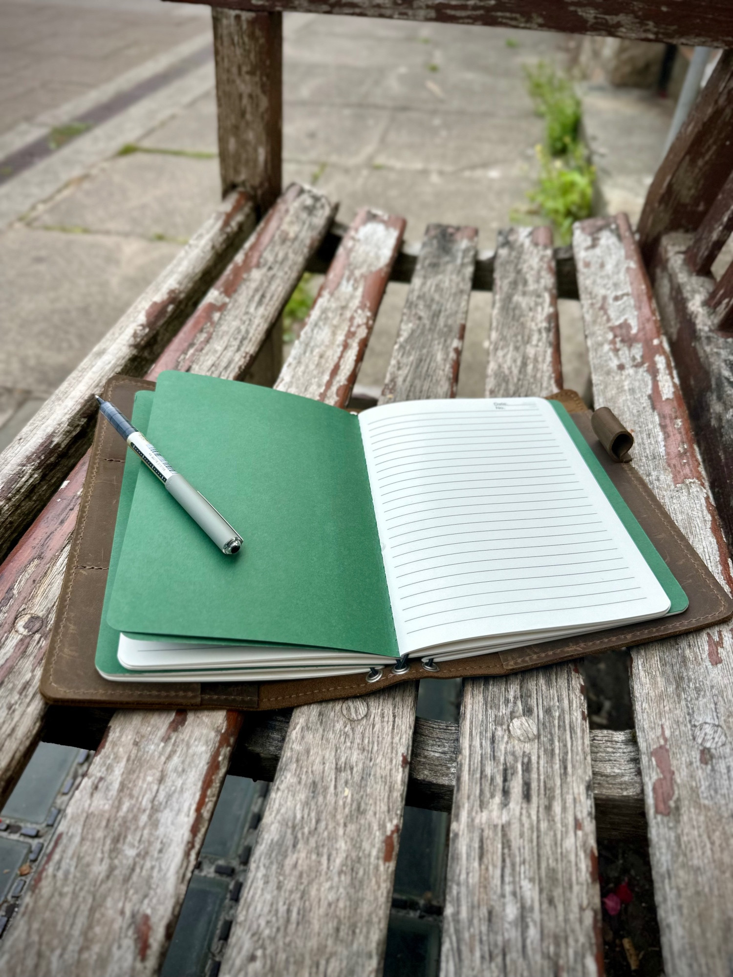 An open notebook on a park bench