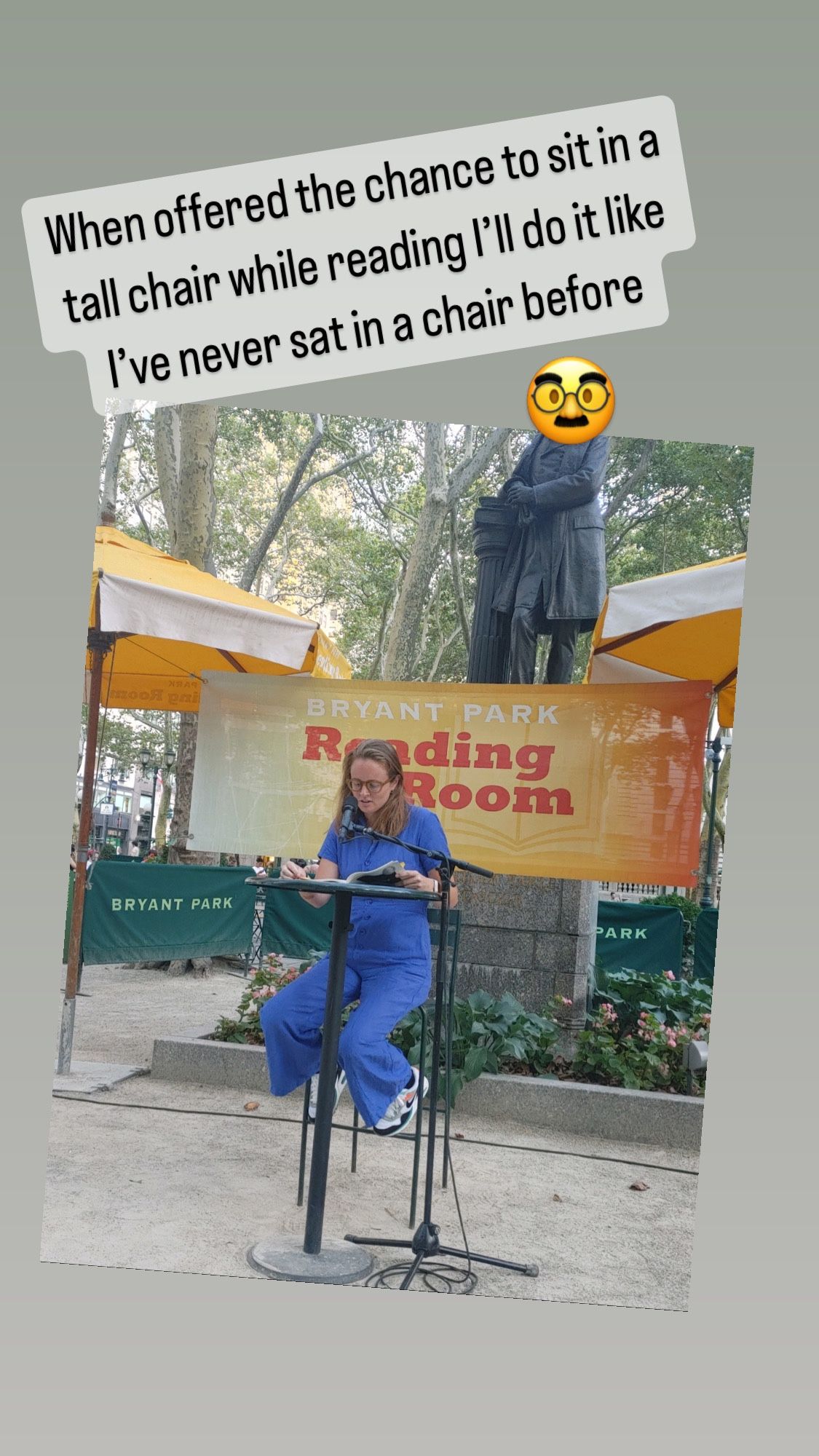 Me sitting awkwardly in a tall chair to read poems in Bryant Park