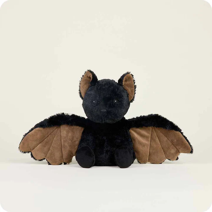 a black and brown plush bat with a kind face