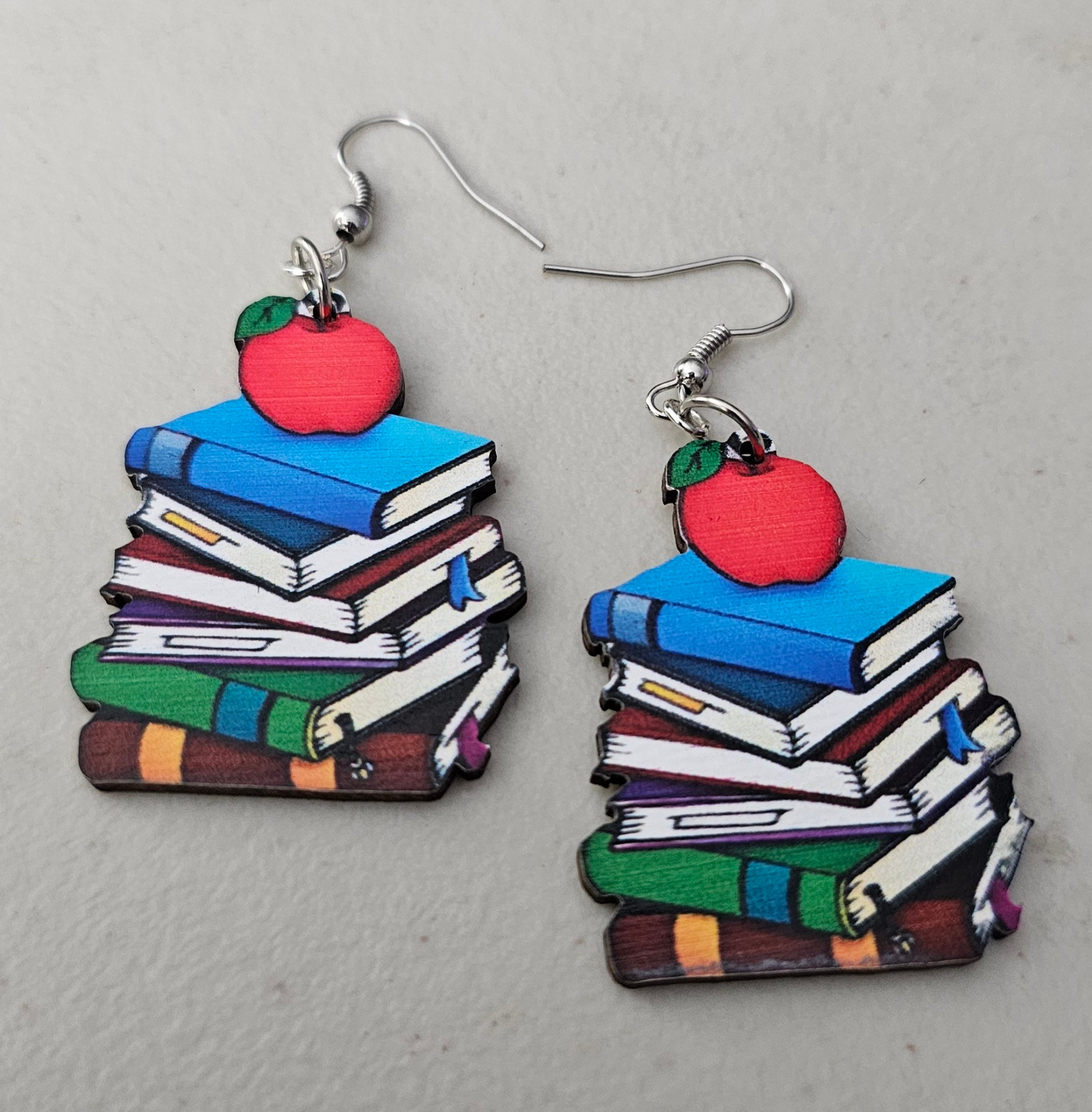Book stacks with an apple on top dangle hook earrings.