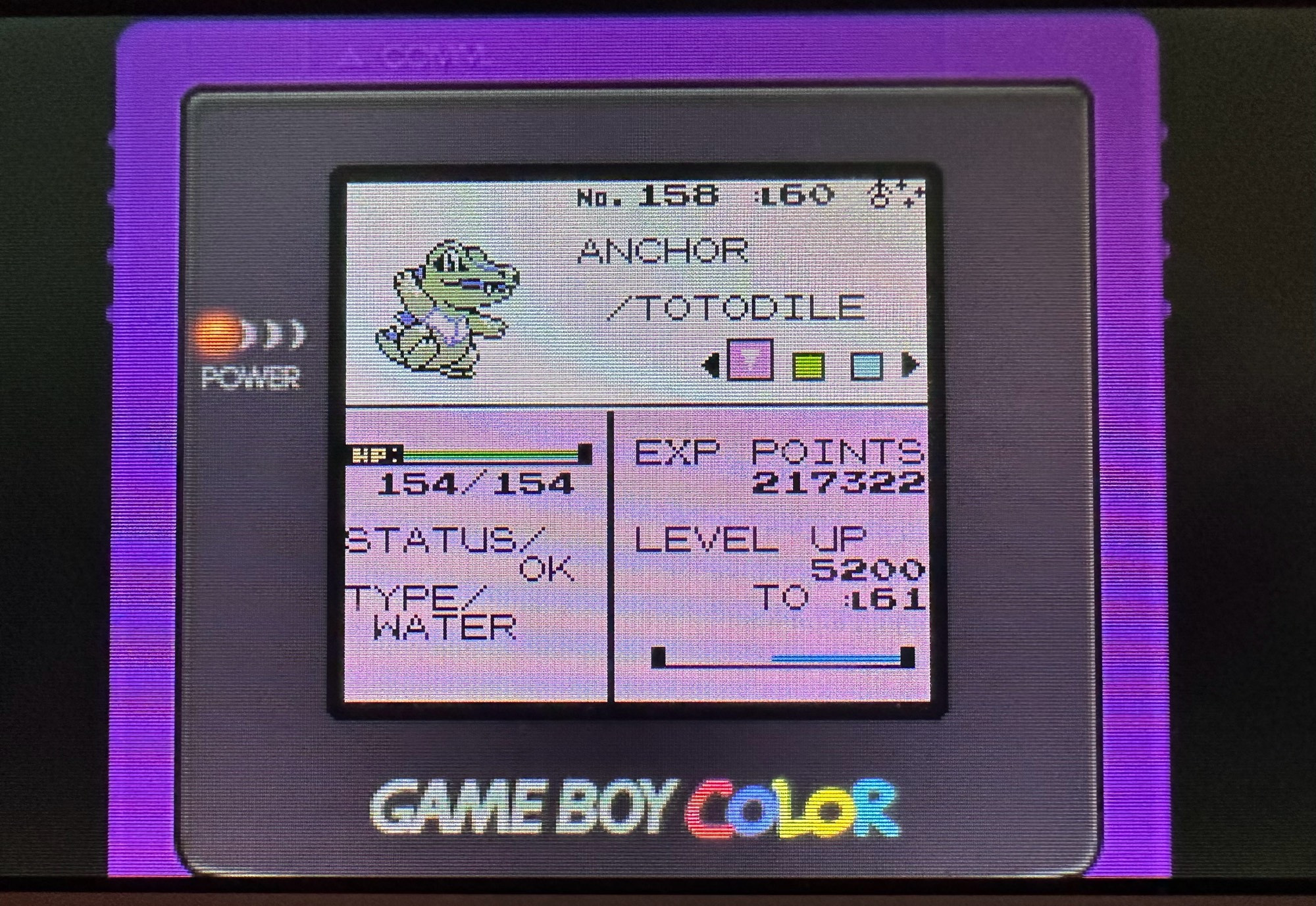 the same shiny totodile from the previous picture, but he is now level 60 and named ‘ANCHOR’. the virtual console game boy colour border is also used in this picture. 