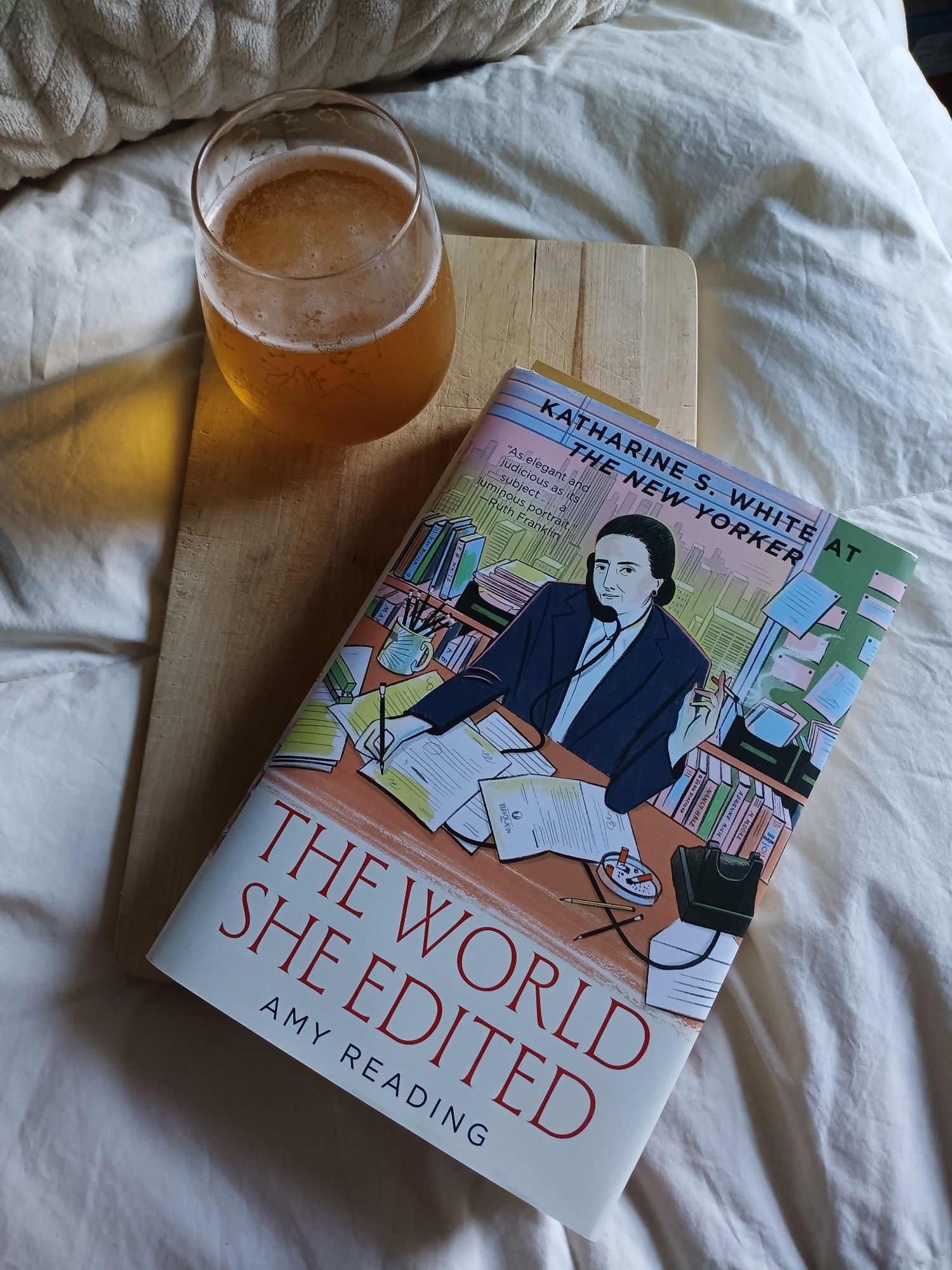 THE WORLD SHE EDITED: KATHARINE S. WHITE AT THE NEW YORKER, by Amy Reading, alongside a glass of N/A beer, against an off-white fabric background