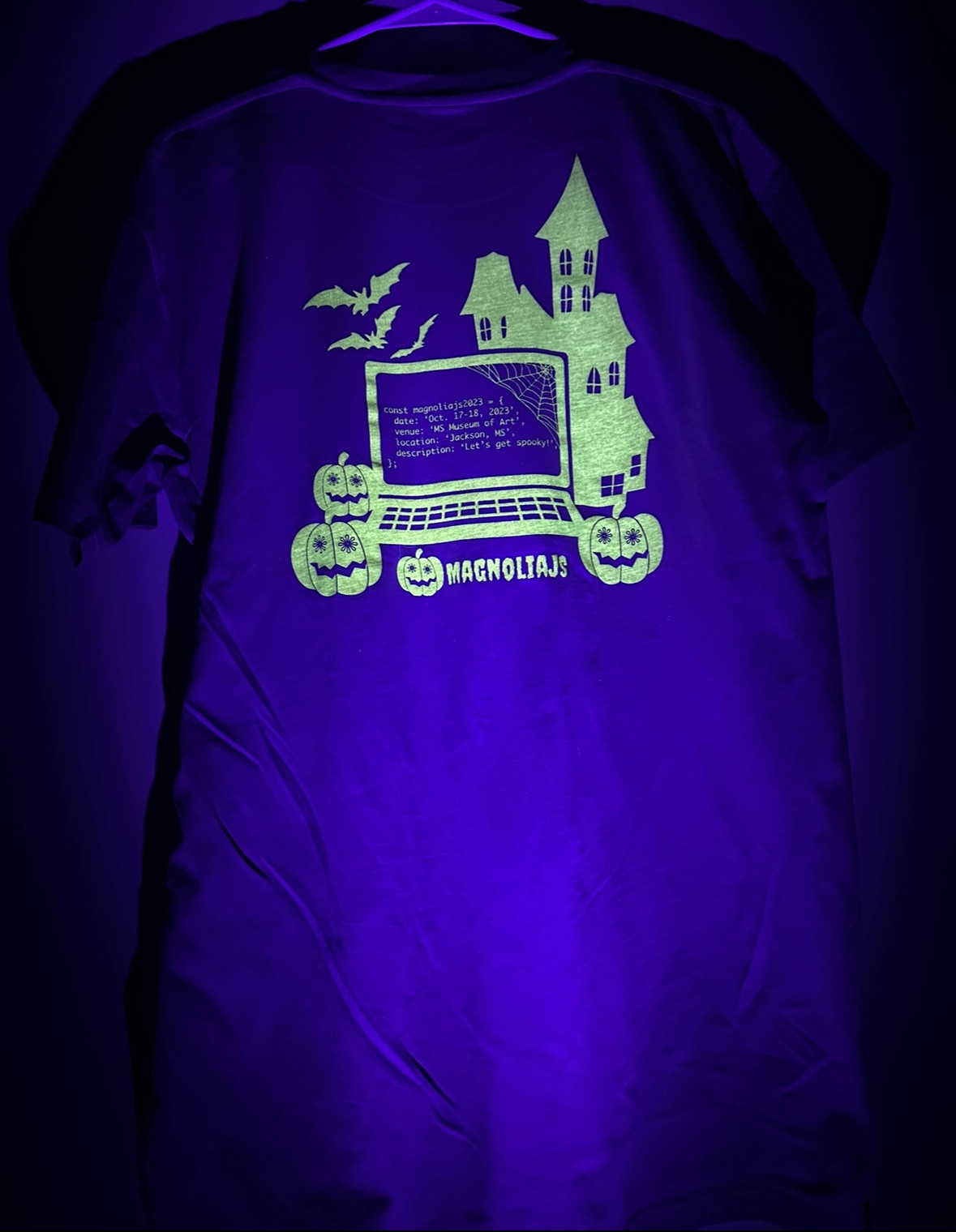 Back of MagnoliaJS 2023 limited-edition t-Shirt glowing in the dark. 