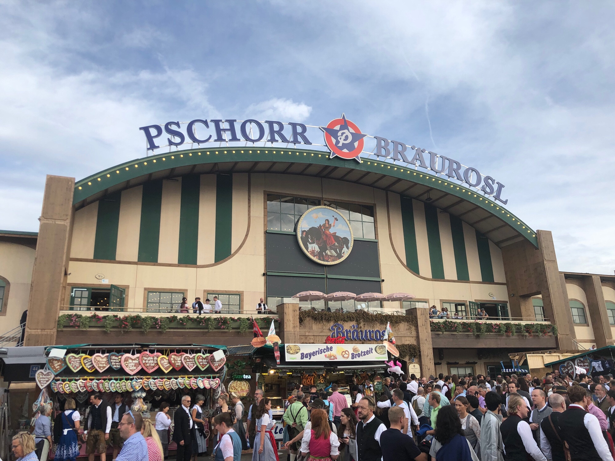 The front gate of a large beer garden, the lettering PSCHORR BRAUROSL is on the roof