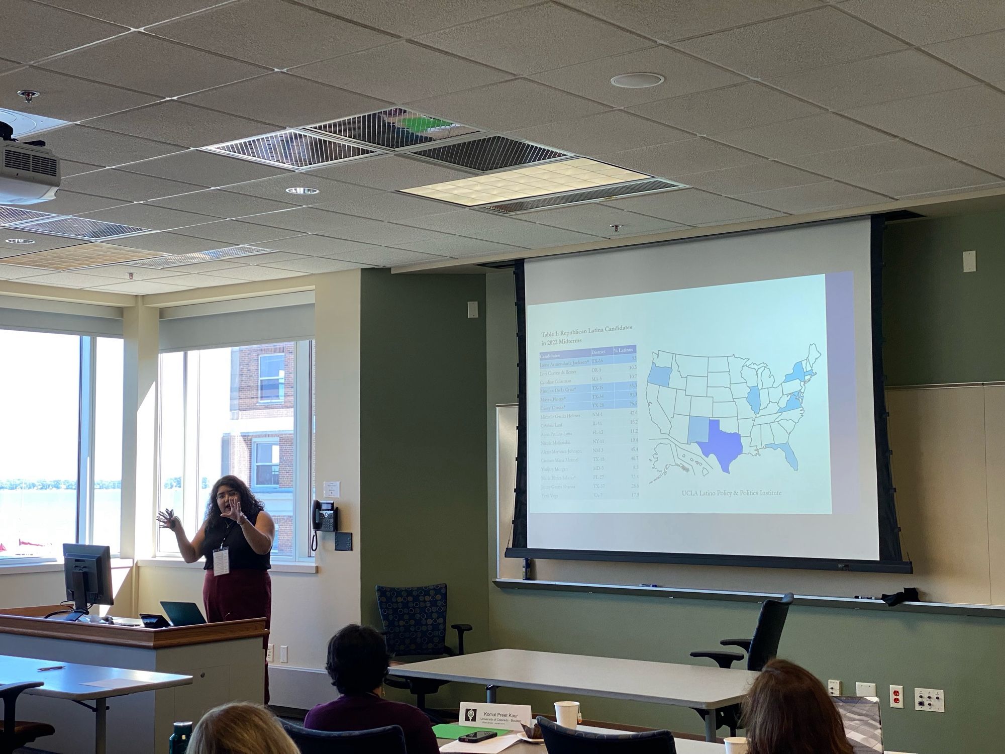 Woman presents in front of a slide with a U.S. map