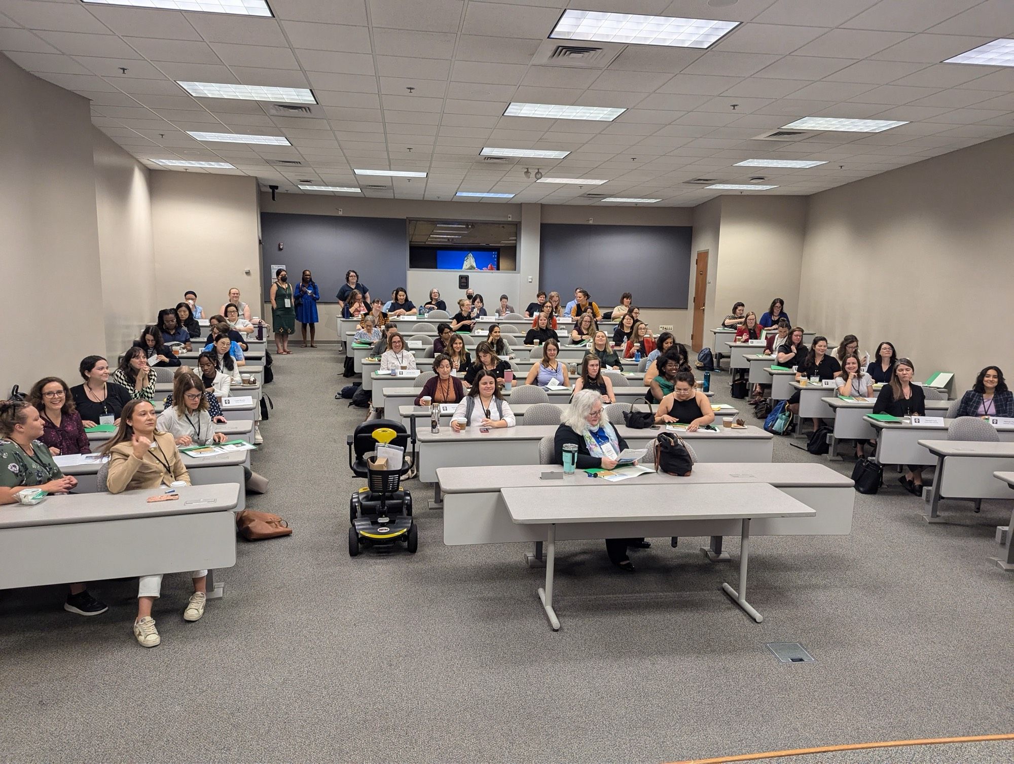 Women seated in rows in a classroom