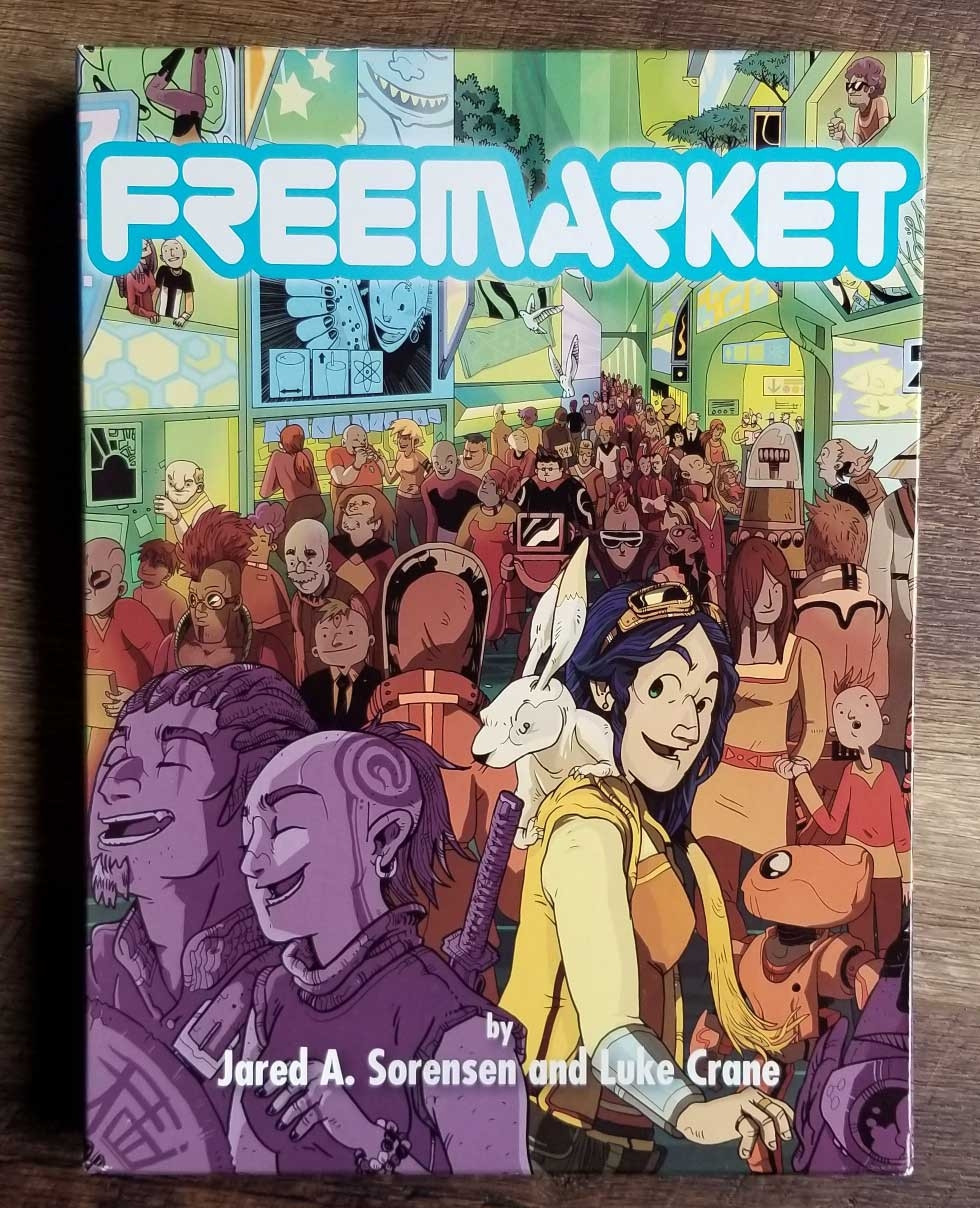 Thr FreeMarket box has art depicting a bustling transhuman space station. Bright. Vibrant. The central focus is on a character in yellow garb, belong black hair, and with a dustbunny (large bio-engerlneered rabbit) on their shoulder. 