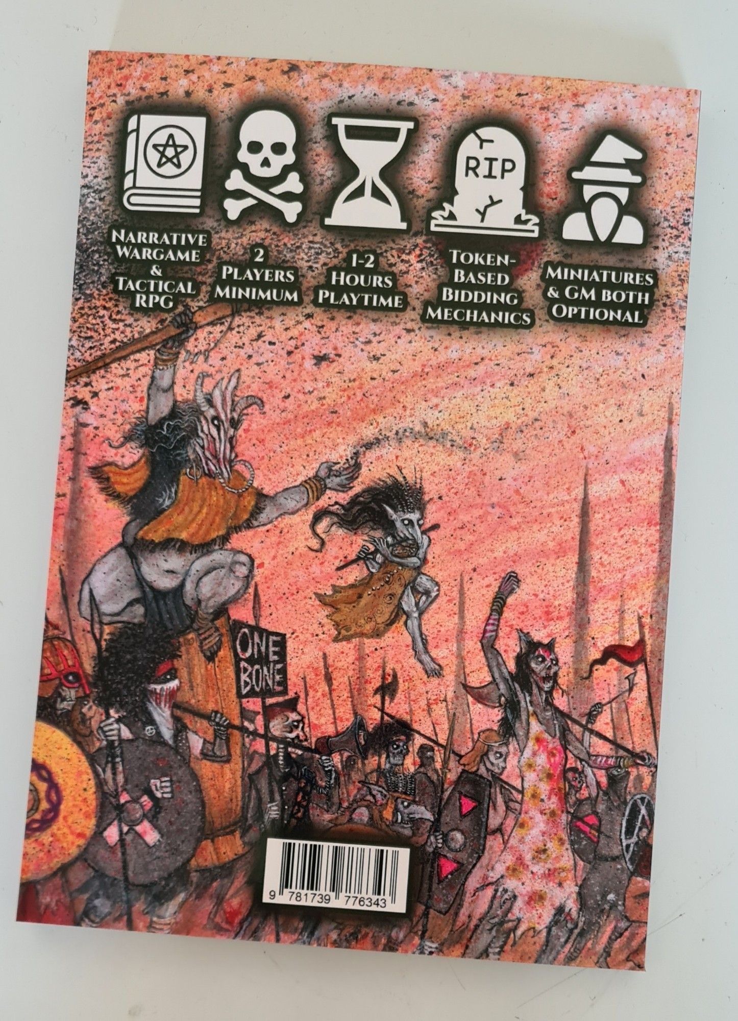 A5 Portrait back cover of Lo! Thy Dread Empire.  The bulk of the space is taken up by more feminist zombies, anarcho-syndicalist skeletons, and a witch riding a large mortar/pot while casting a spell and a goblin-like spirit hovering in the air plaguing a flute. Above this scene are some symbols and text indicating that this is a narrative wargame & tactical RPG for 2 players minimum, 1-2h playtime, using token-based bidding mechanics, and miniatures/GM optional.