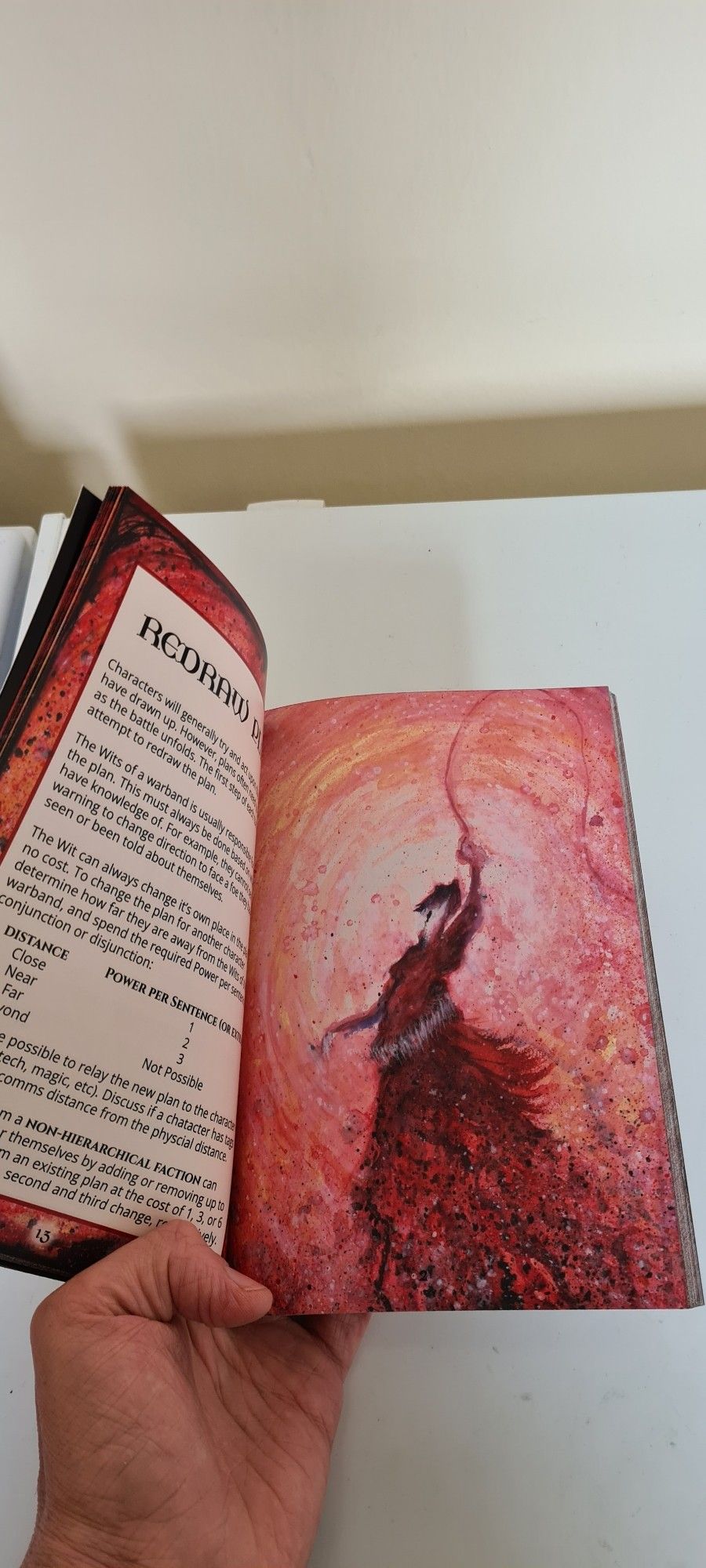 Inside spread with text on the left and a full page piece of art on the right. The art is an impressionist if piece of a faceless demon wielding a whip.