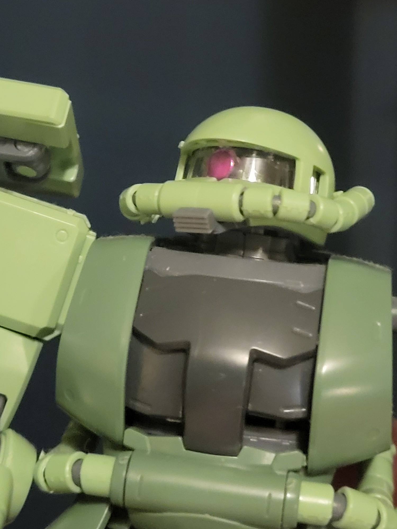 A Master Grade Zaku II viewed from the waist up: the monoeye has been colored in with a metallic marker