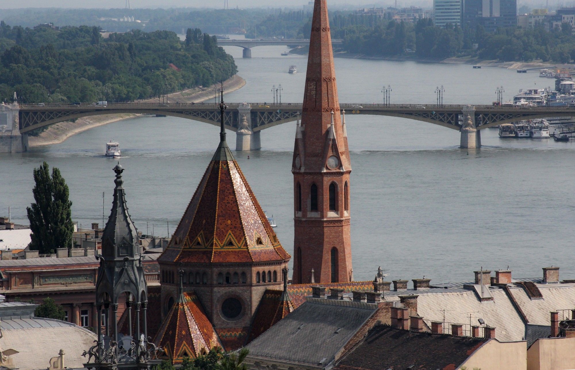 Church spires and building rooftops with river and bridges in background