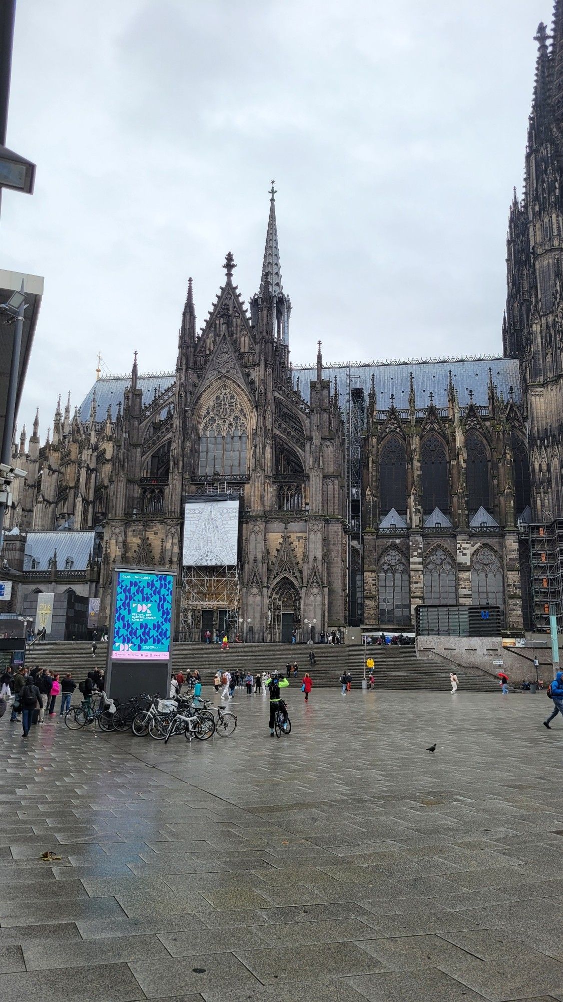 Open square in front of very large, very old cathedral. Gray, rainy skies