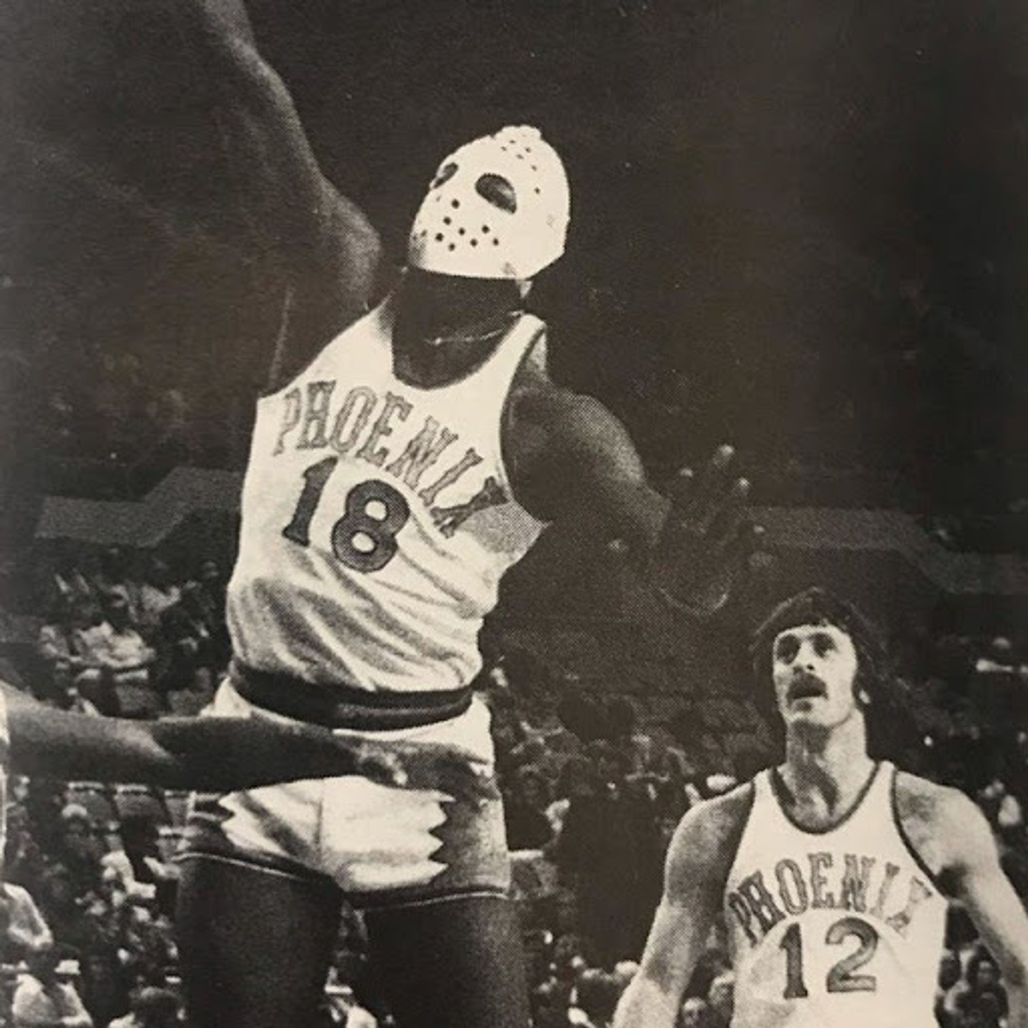 B&W pic - #18 Curtis Perry (early Suns) putting up a lay-in - wearing a Phoenix Roadrunners hockey mask to protect facial injury. #12 future Lakers HC Pat Riley - Suns - trailing behind.