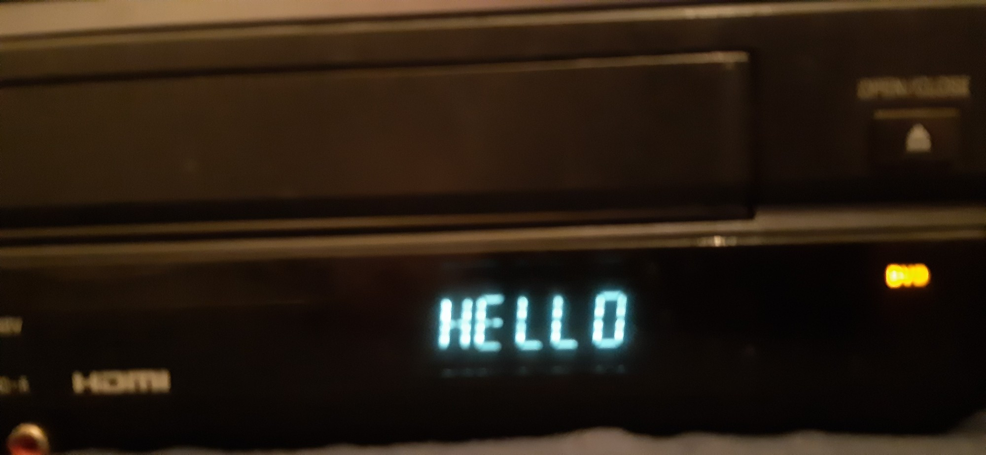 A black VCR/DVD combo unit saying HELLO