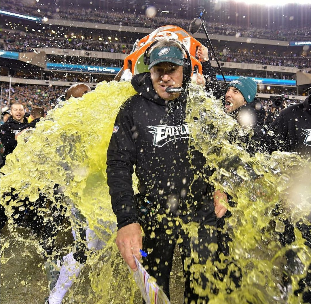 Picture of a football coach being drenched with Gatorade.