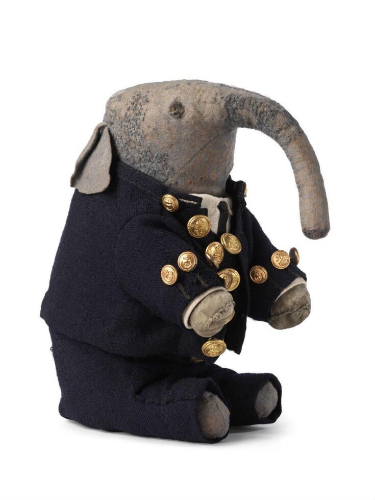 Extant stuffed toy elephant, gray with navy colored jacket and trousers 