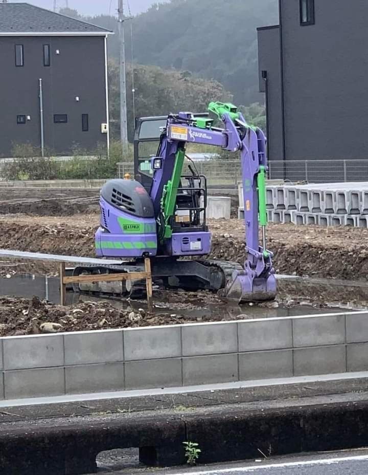 One of those construction claw machines, but it's painted in purple and green like the famous giant robots from Neon Genesis Evangelion.