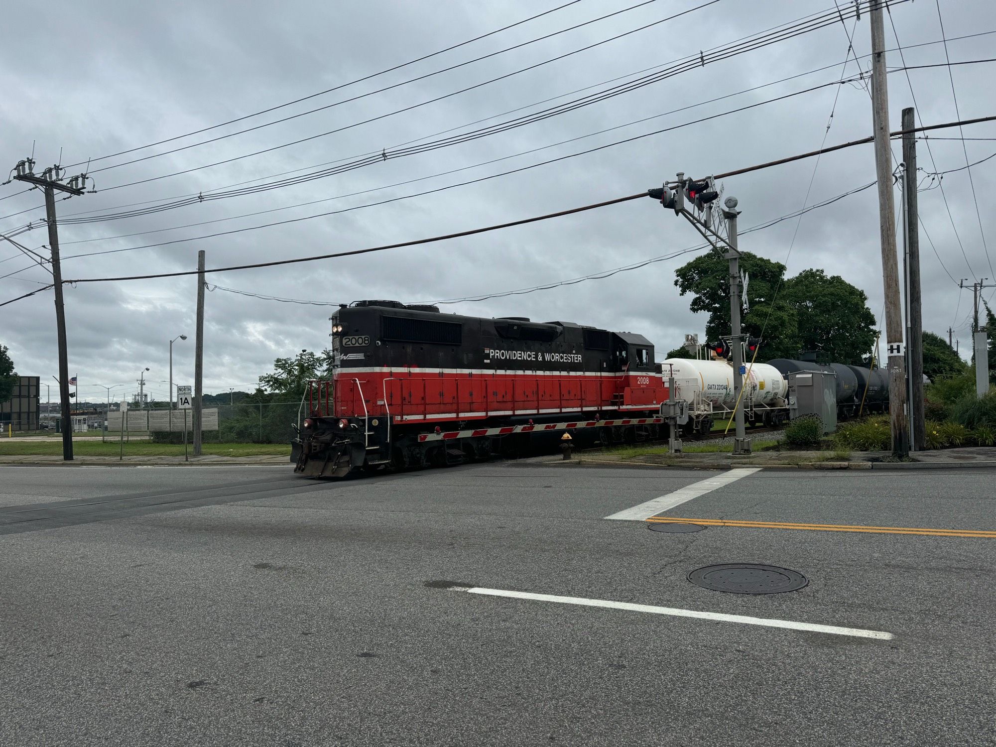 A train crossing an intersection just past a traffic light