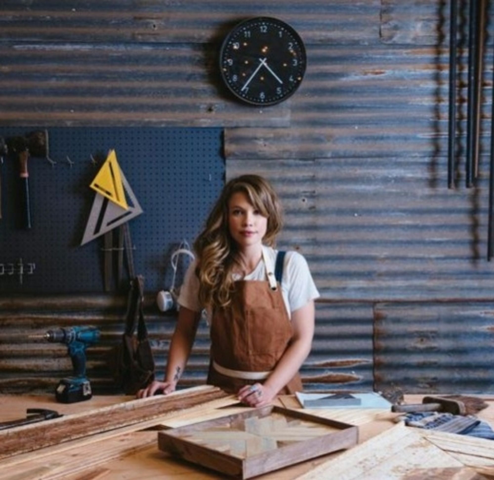 A young woman busy at her carpentry.